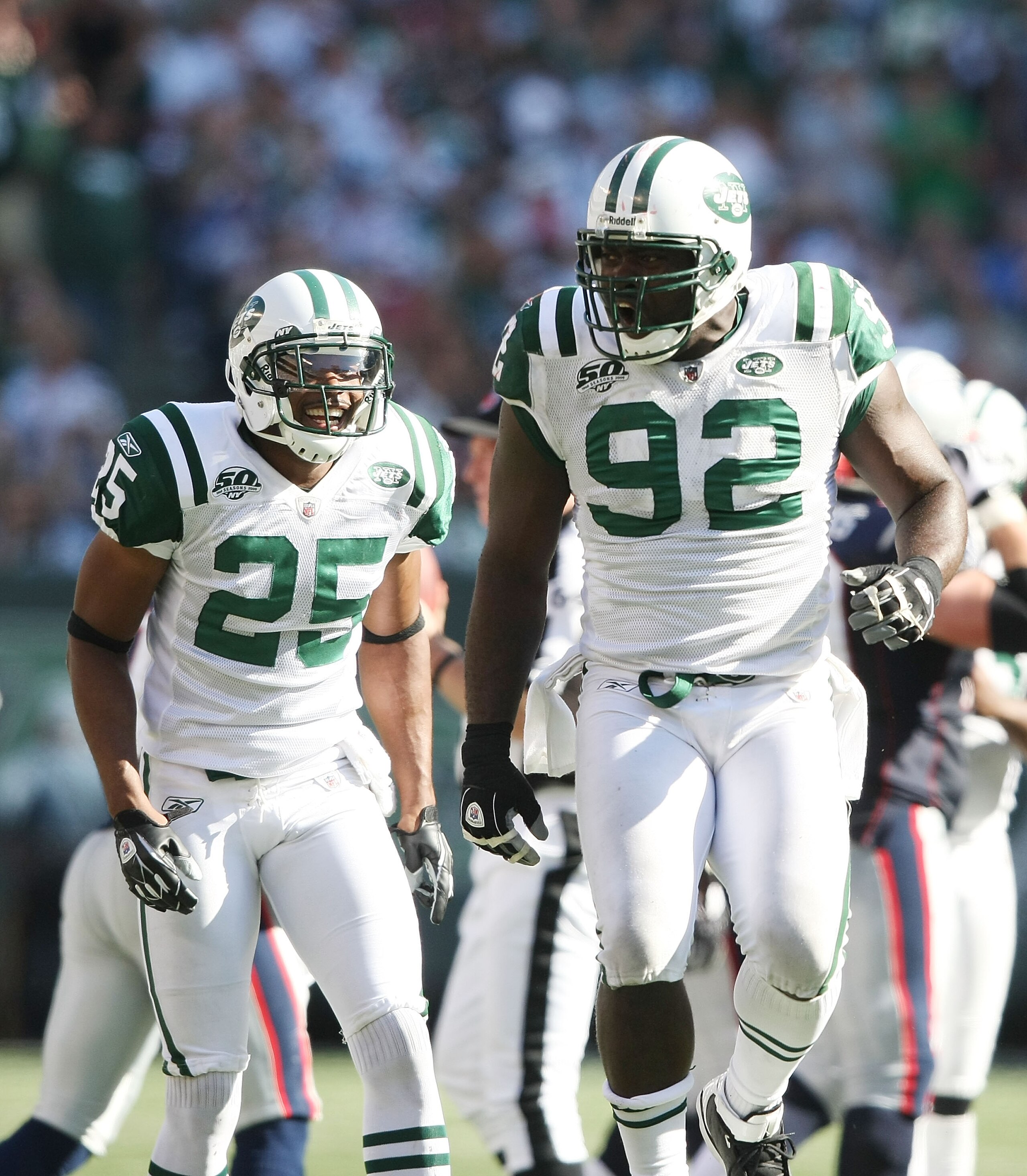 EAST RUTHERFORD, NJ - SEPTEMBER 20: Shaun Ellis #92 of the New York Jets celebrates a play in front of teammate Kerry Rhodes #25 against the New England Patriots at Giants Stadium on September 20, 2009 in East Rutherford, New Jersey. (Photo by Nick Laham EAST RUTHERFORD, NJ - SEPTEMBER 20: Shaun Ellis #92 of the New York Jets celebrates a play in front of teammate Kerry Rhodes #25 against the New England Patriots at Giants Stadium on September 20, 2009 in East Rutherford, New Jersey. (Photo by Nick Laham