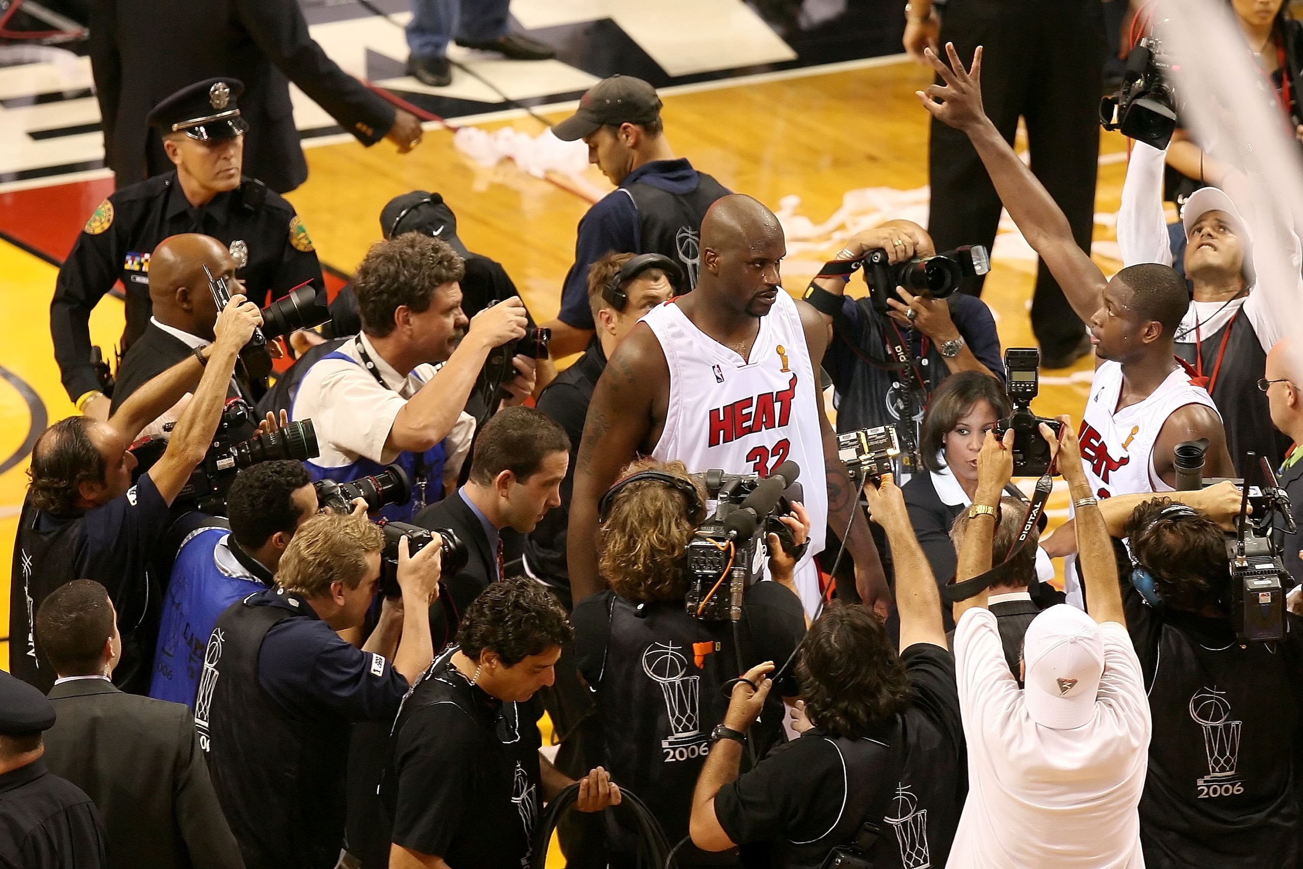 MIAMI - JUNE 18:  Shaquille O'Neal #32 and Dwyane Wade #3 of the Miami Heat are surrounded by the media after their overtime victory over the Dallas Mavericks in game five of the 2006 NBA Finals on June 18, 2006 at American Airlines Arena in Miami, Florid
