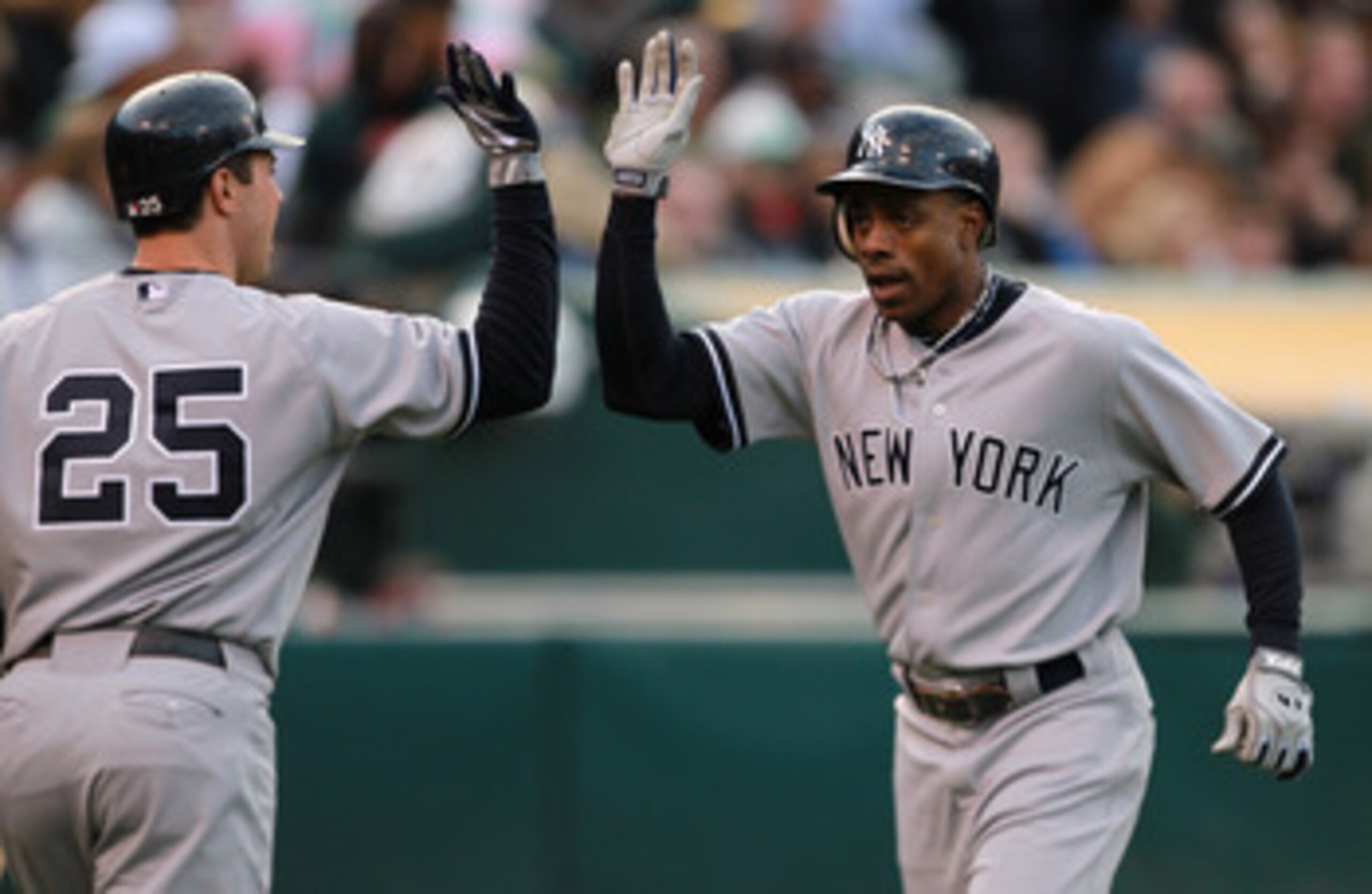 OAKLAND, CA - MAY 31:  Curtis Granderson #14 of the New York Yankees is congratulated by Mark Teixeira #25 of the New York Yankees after he hit a two run home run in the first inning against the Oakland Athletics at Oakland-Alameda County Coliseum on May