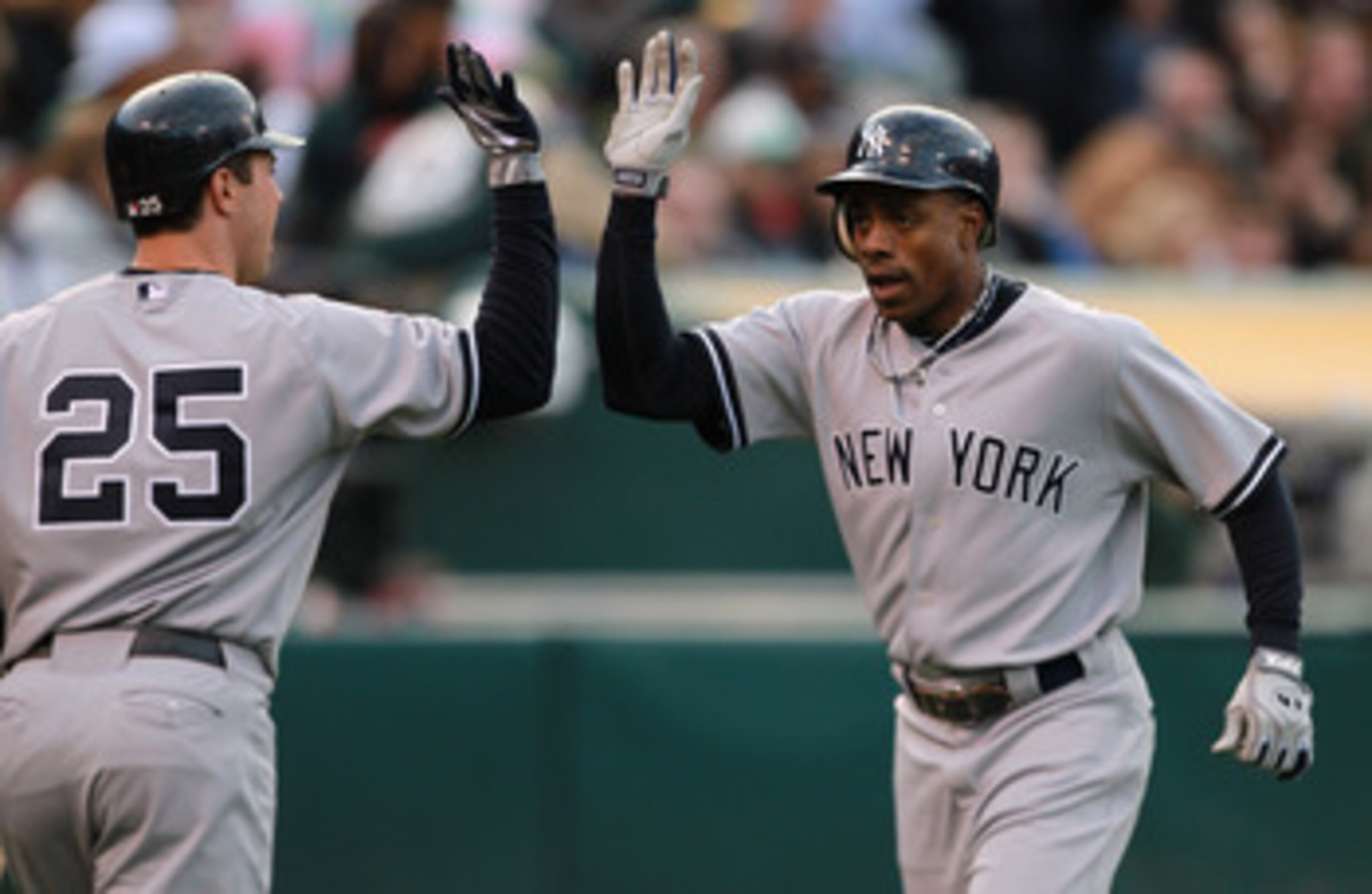 OAKLAND, CA - MAY 31:  Curtis Granderson #14 of the New York Yankees is congratulated by Mark Teixeira #25 of the New York Yankees after he hit a two run home run in the first inning against the Oakland Athletics at Oakland-Alameda County Coliseum on May