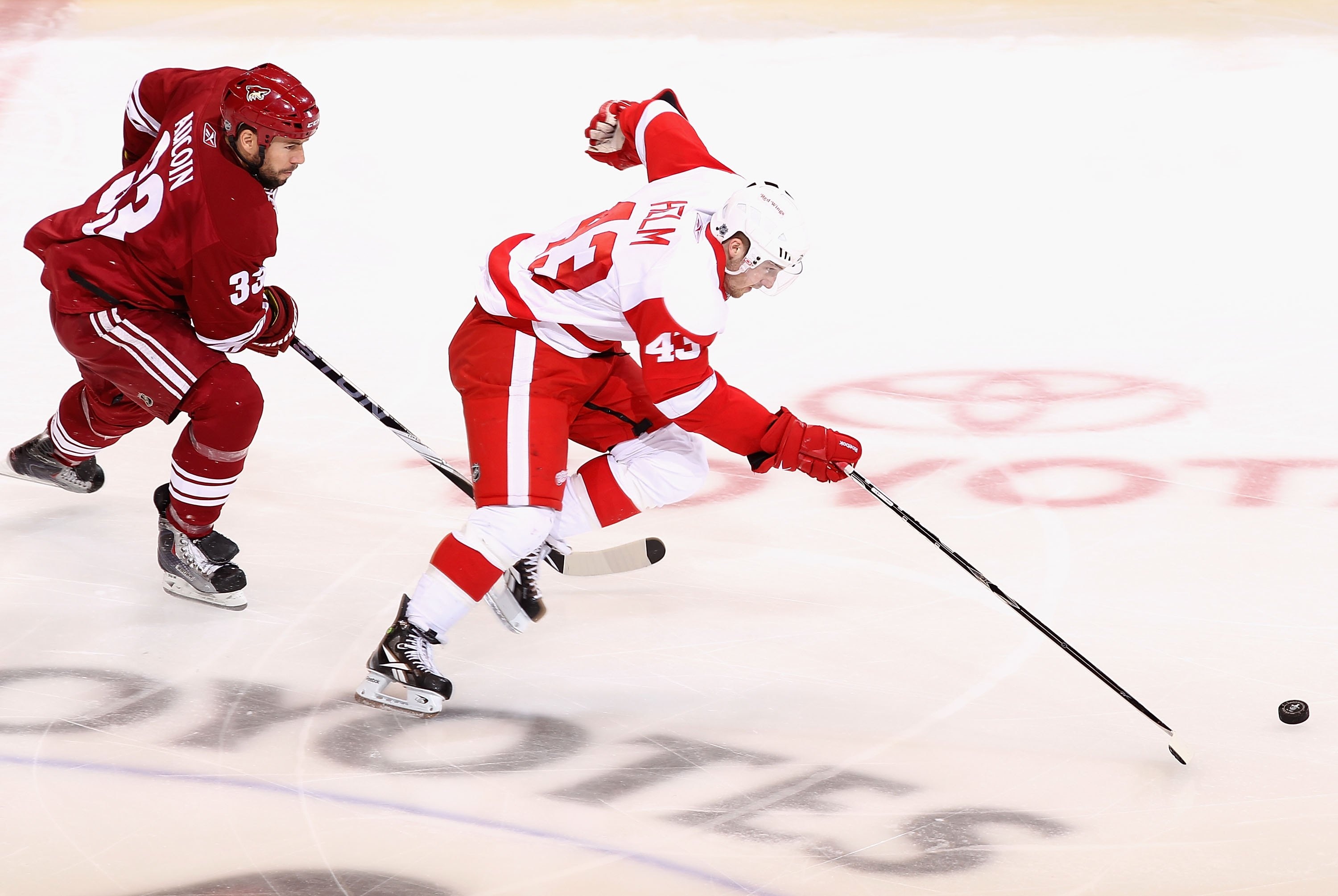 GLENDALE, AZ - APRIL 27:  Darren Helm #43 of the Detroit Red Wings skates with the puck past the Phoenix Coyotes in Game Seven of the Western Conference Quarterfinals during the 2010 NHL Stanley Cup Playoffs at Jobing.com Arena on April 27, 2010 in Glenda