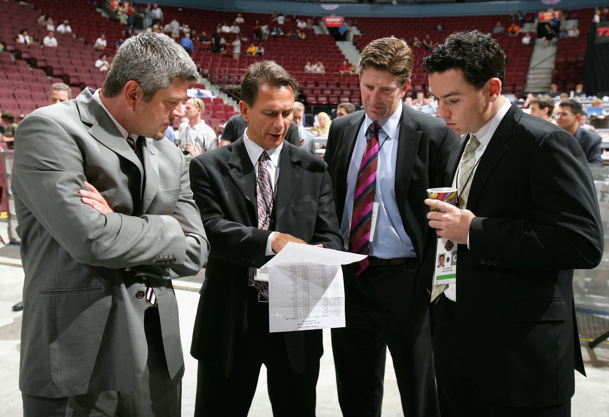 VANCOUVER, BC - JUNE 24:  (L-R) Assistant coach Todd McLellan, general manager Ken Holland, head coach Mike Babcock, and video coach Jay Woodcroft of the Detroit Red Wings convene during the 2006 NHL Draft held at General Motors Place on June 24, 2006 in