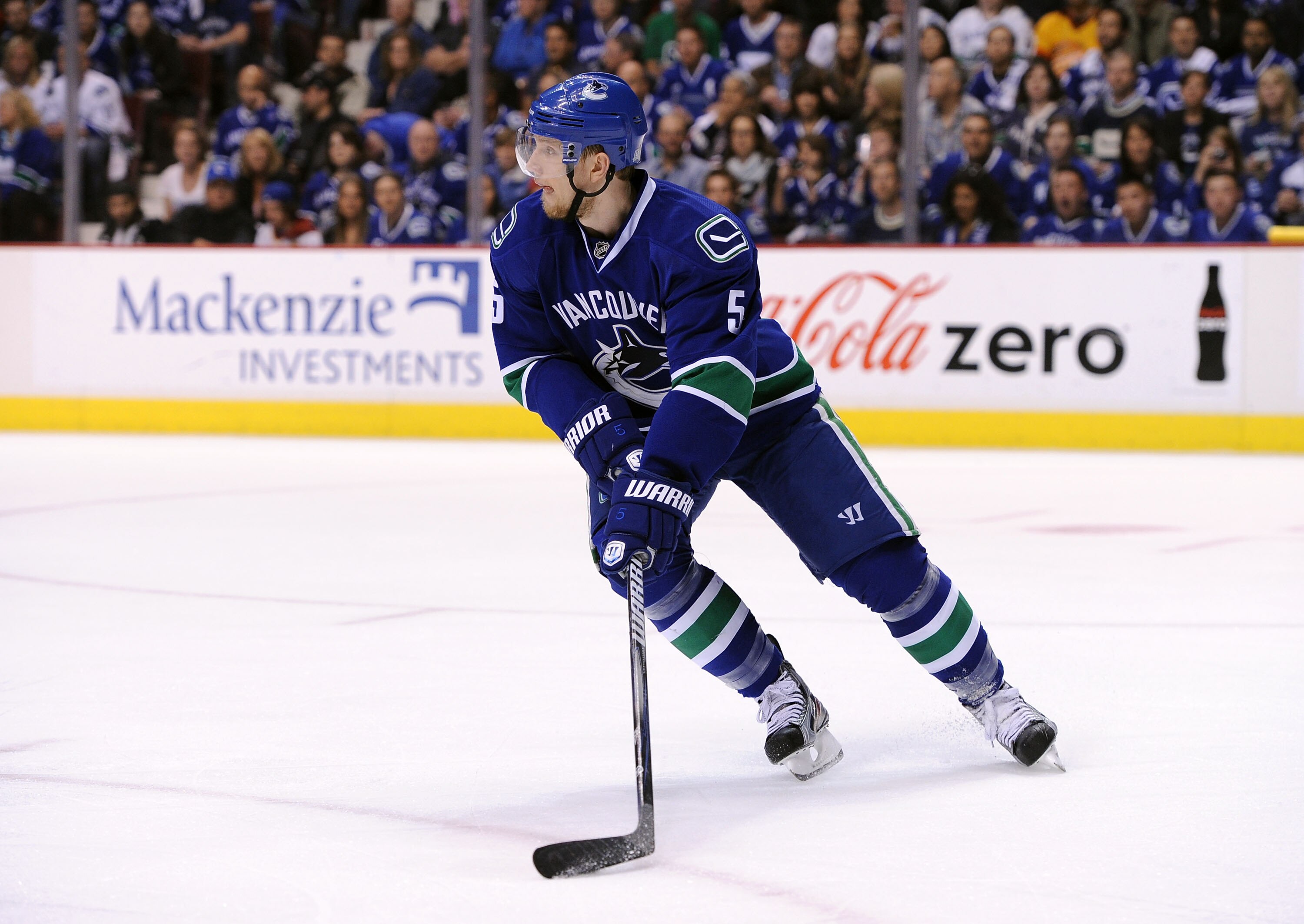 VANCOUVER, CANADA - MAY 15:  Christian Ehrhoff #5 of the Vancouver Canucks looks to pass the puck out of the defensive zone against the San Jose Sharks in the first period in Game One of the Western Conference Finals during the 2011 Stanley Cup Playoffs a