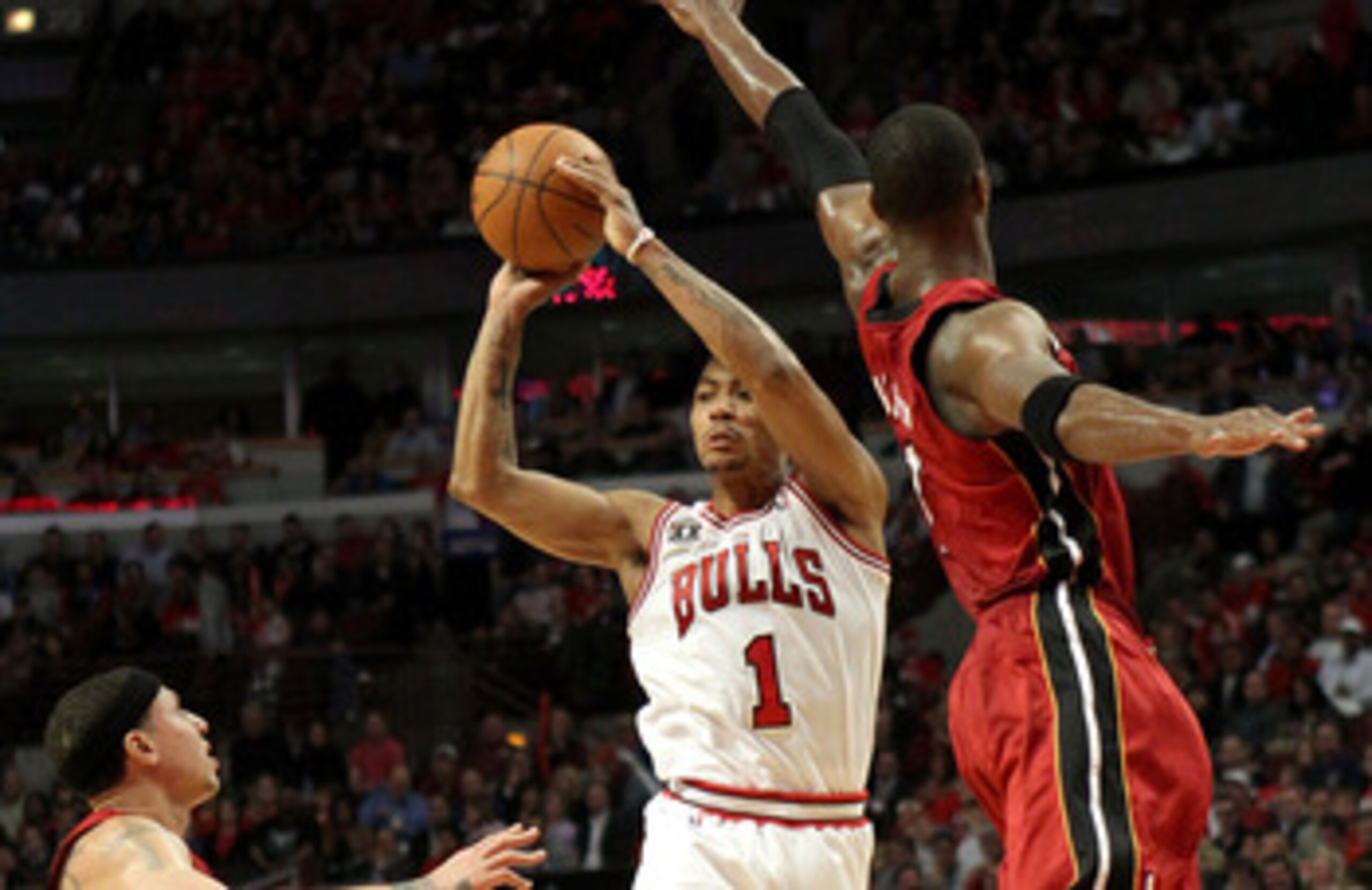 CHICAGO, IL - MAY 26:  Derrick Rose #1 of the Chicago Bulls looks to pass against Chris Bosh #1 and Mike Bibby #0 of the Miami Heat in Game Five of the Eastern Conference Finals during the 2011 NBA Playoffs on May 26, 2011 at the United Center in Chicago,