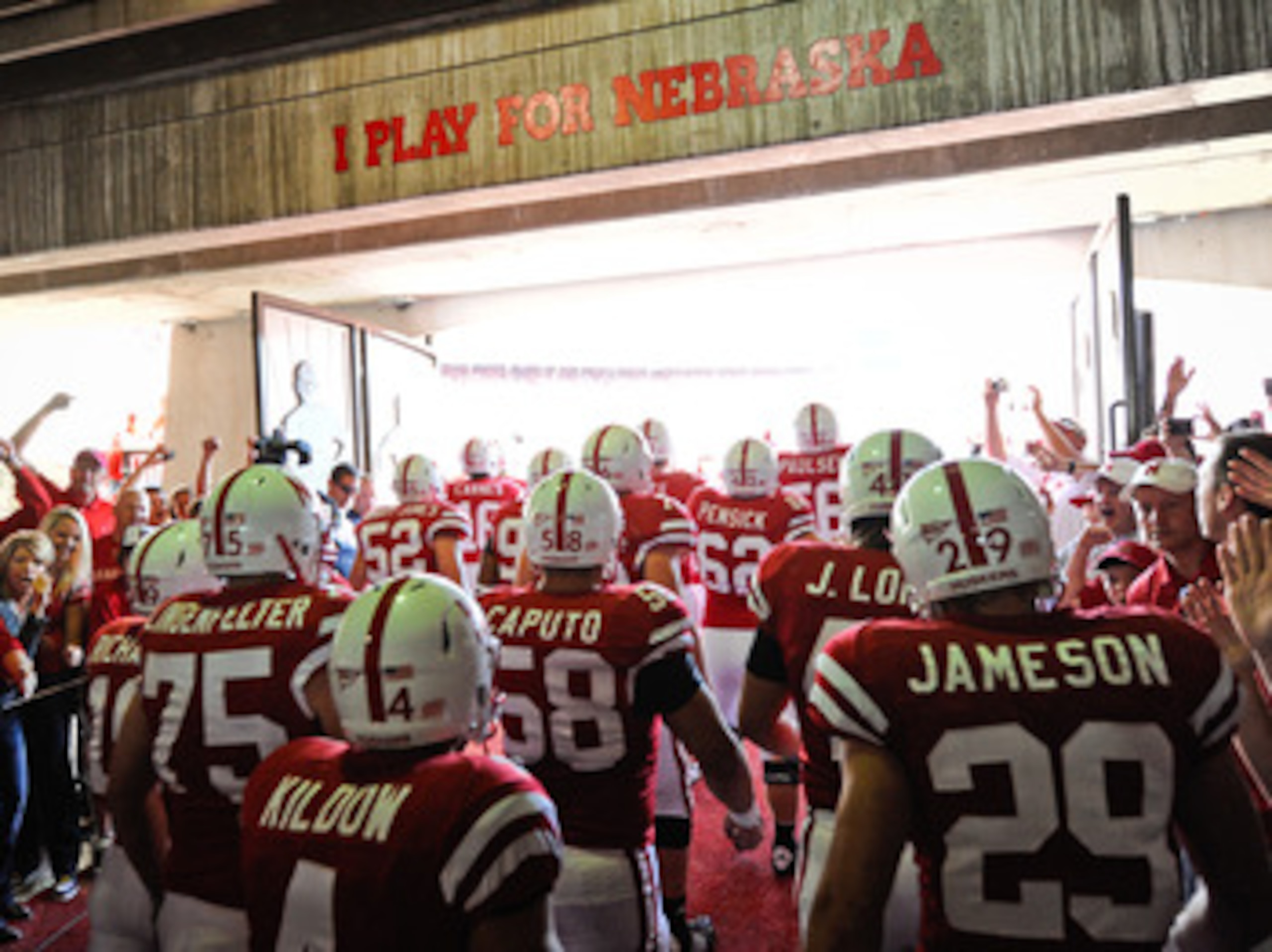LINCOLN, NE - OCTOBER 16: The Nebraska Cornuskers run through a gauntlet of fans as they take the field against the Texas Longhorns at Memorial Stadium on October 16, 2010 in Lincoln, Nebraska. Texas Defeated Nebraska 20-13. (Photo by Eric Francis/Getty I