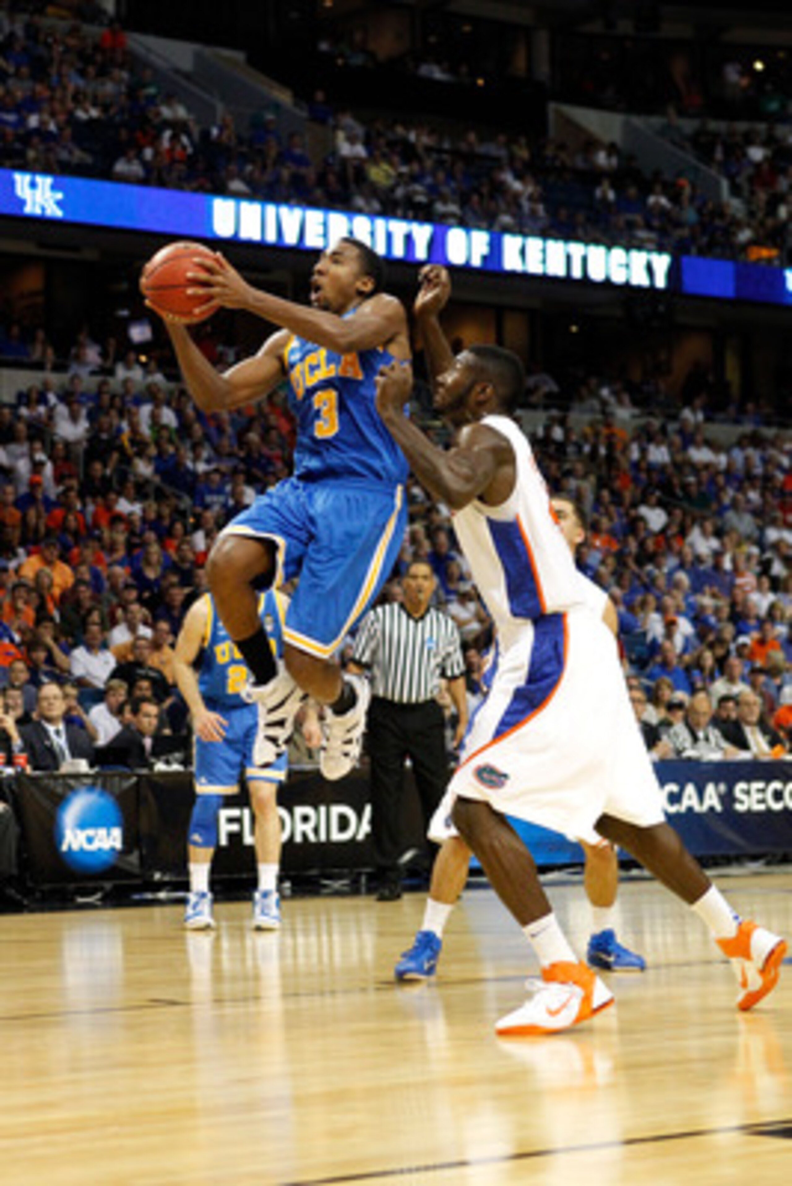 TAMPA, FL - MARCH 19:  Malcolm Lee #3 of the UCLA Bruins drives for a shot attempt against Patric Young #4 of the Florida Gators during the third round of the 2011 NCAA men's basketball tournament at St. Pete Times Forum on March 19, 2011 in Tampa, Florid