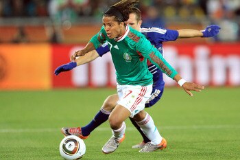 POLOKWANE, SOUTH AFRICA - JUNE 17:  Giovani Dos Santos of Mexico beats Franck Ribery of France during the 2010 FIFA World Cup South Africa Group A match between France and Mexico at the Peter Mokaba Stadium on June 17, 2010 in Polokwane, South Africa.  (P