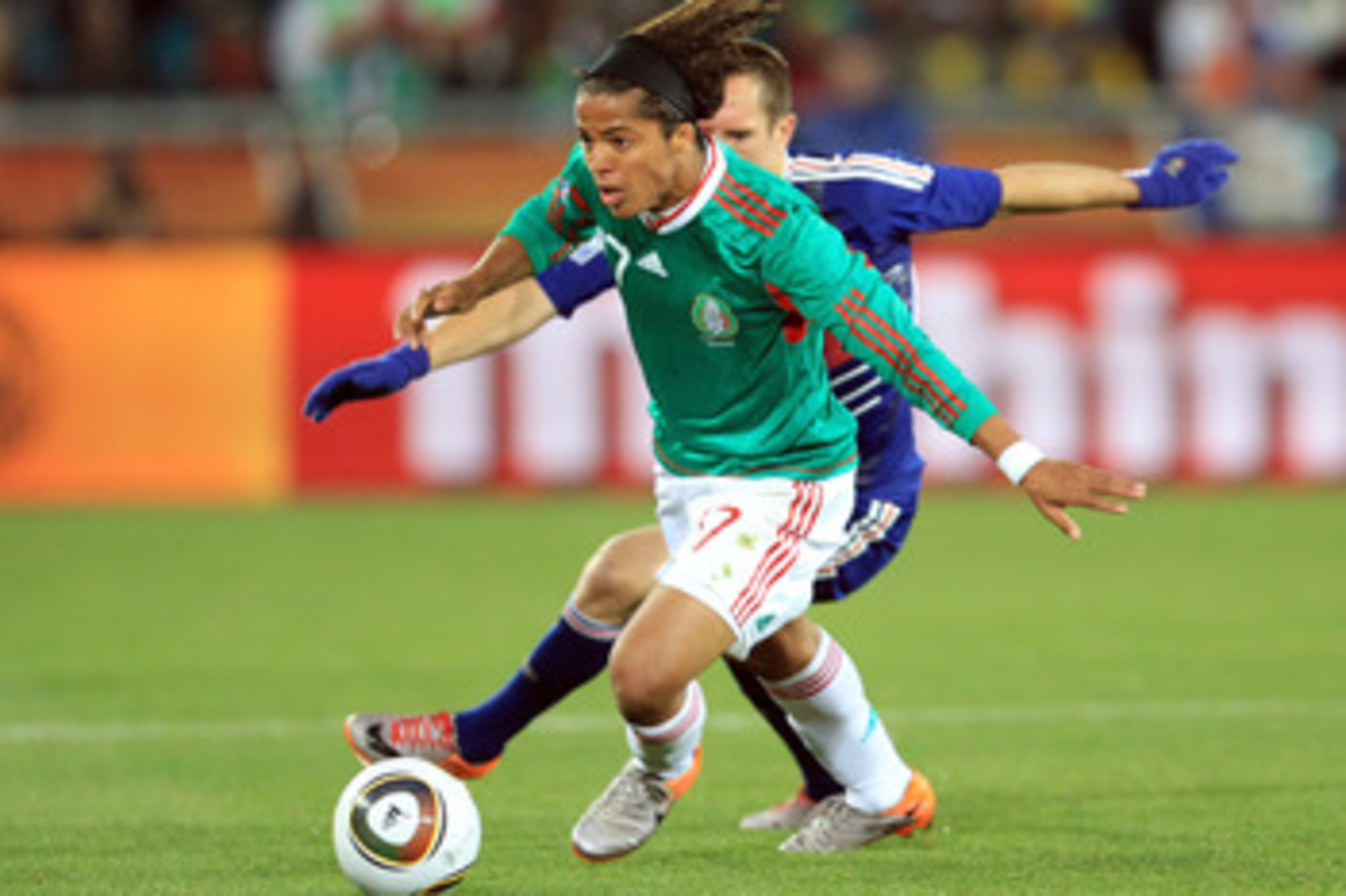 POLOKWANE, SOUTH AFRICA - JUNE 17:  Giovani Dos Santos of Mexico beats Franck Ribery of France during the 2010 FIFA World Cup South Africa Group A match between France and Mexico at the Peter Mokaba Stadium on June 17, 2010 in Polokwane, South Africa.  (P