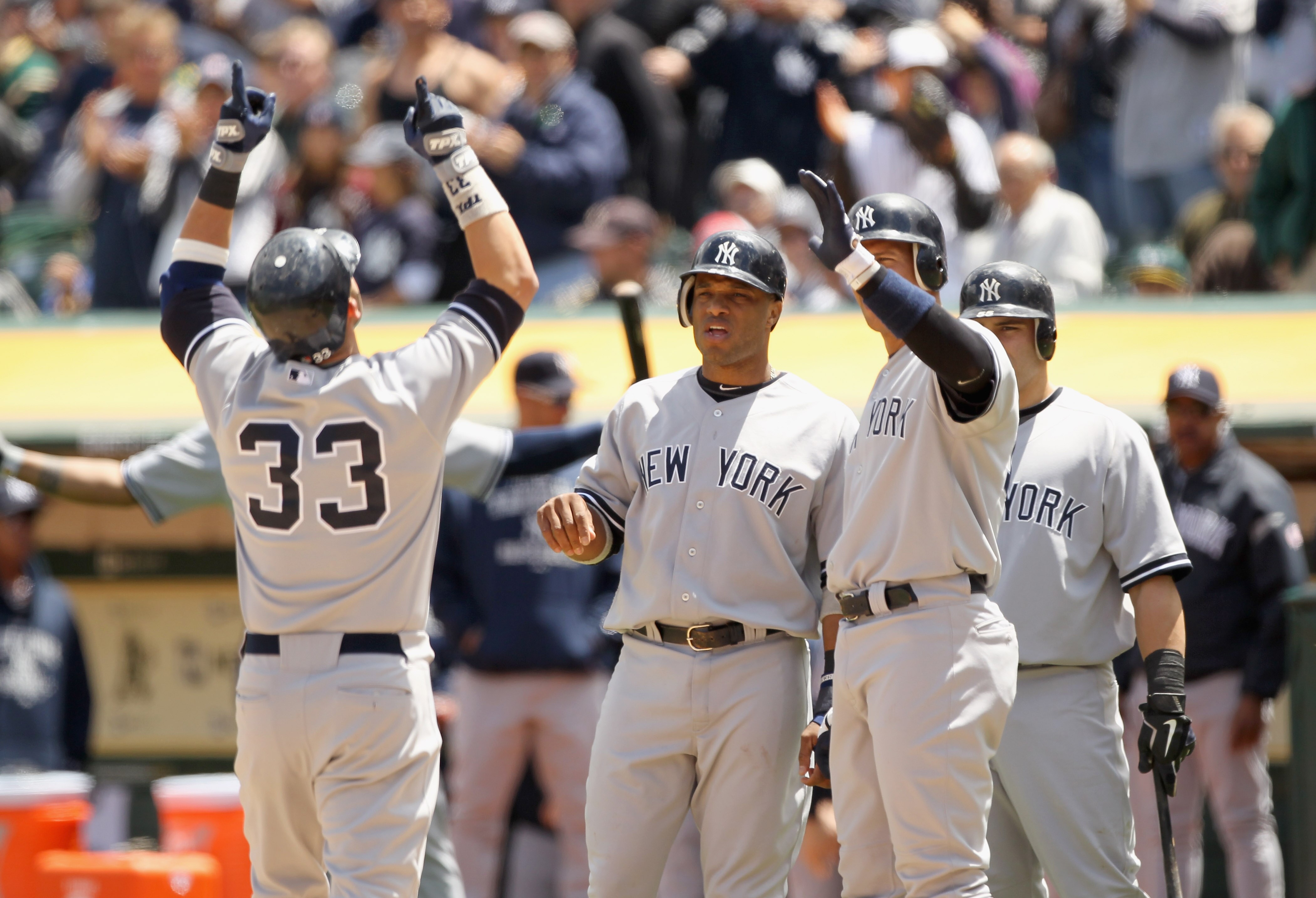 OAKLAND, CA - JUNE 01:  Nick Swisher #33 of the New York Yankees is congratulated by Robinson Cano #24 and Alex Rodriguez #13 after he hit a three run home run in the fourth inning against the Oakland Athletics at Oakland-Alameda County Coliseum on June 1