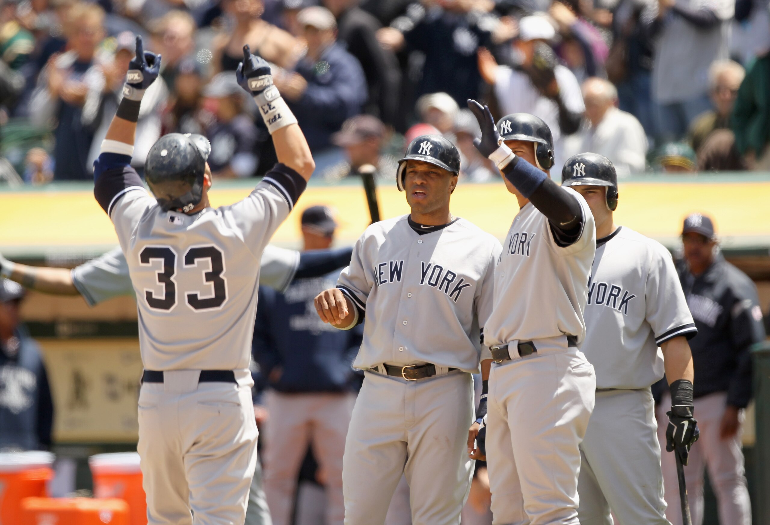 OAKLAND, CA - JUNE 01:  Nick Swisher #33 of the New York Yankees is congratulated by Robinson Cano #24 and Alex Rodriguez #13 after he hit a three run home run in the fourth inning against the Oakland Athletics at Oakland-Alameda County Coliseum on June 1