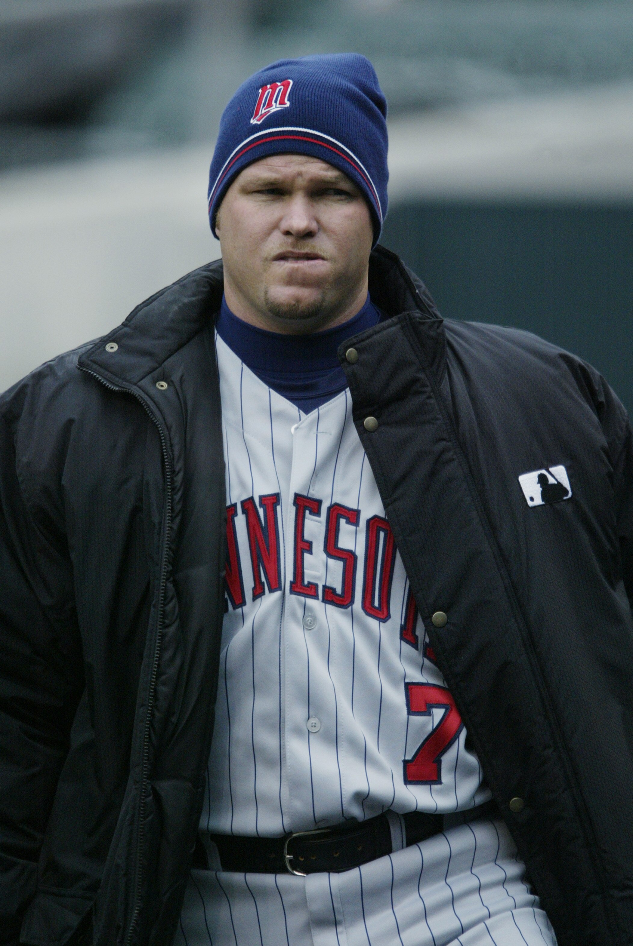 DETROIT- APRIL 3:  Third baseman Denny Hocking #7 of the Minnesota Twins tries to keep warm in the dugout during the game against the Detroit Tigers at Comerica Park on April 3, 2003 in Detroit, Minnesota.  The Twins won 3-0.  (Photo by Tom Pidgeon/Getty