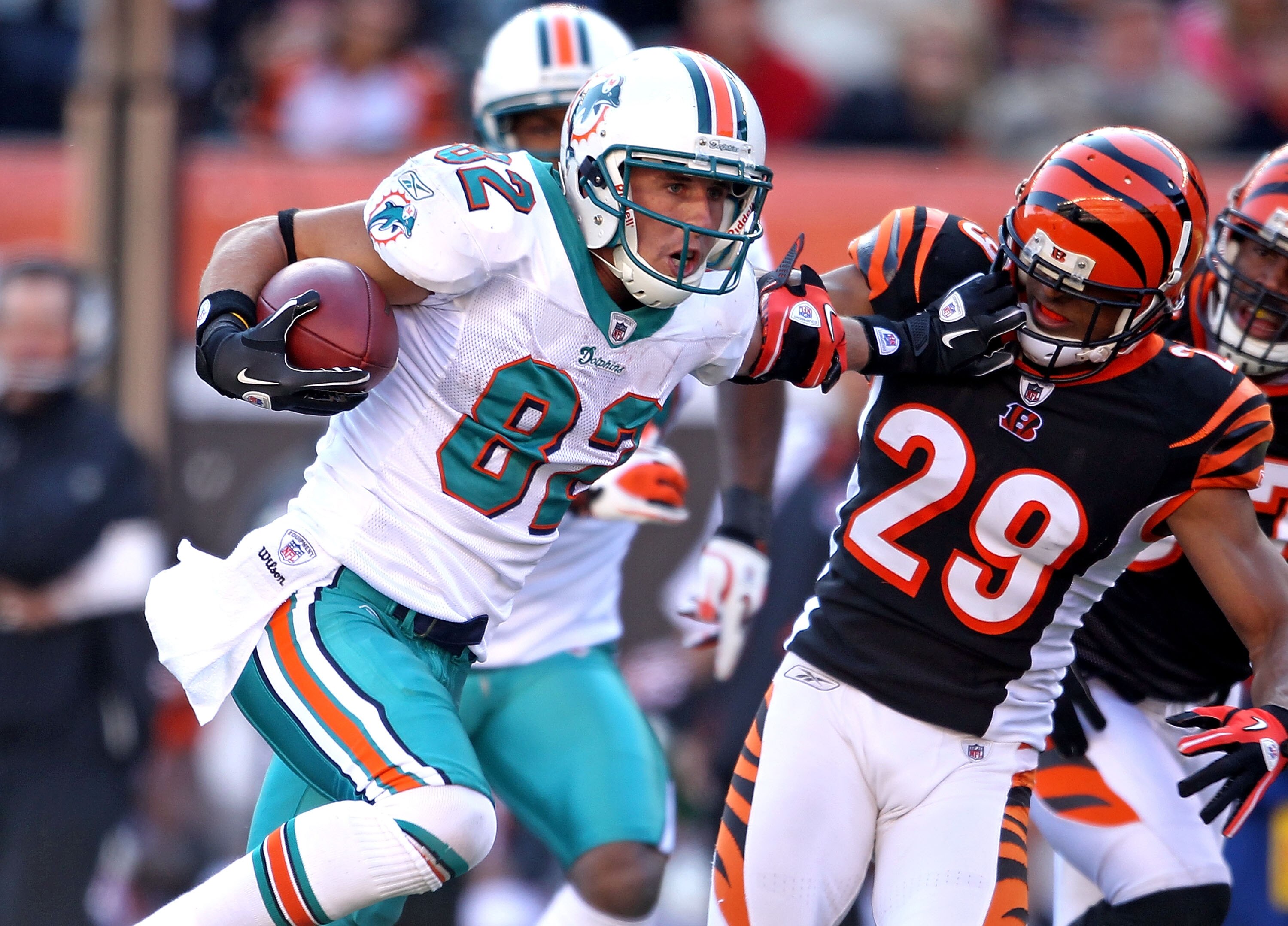 CINCINNATI - OCTOBER 31:  Brian Hartline #82 of the Miami Dolphins runs with the ball while defended by Leon Hall #29  of the Cincinnati Bengals during the NFL game at Paul Brown Stadium on October 31, 2010 in Cincinnati, Ohio.  (Photo by Andy Lyons/Getty