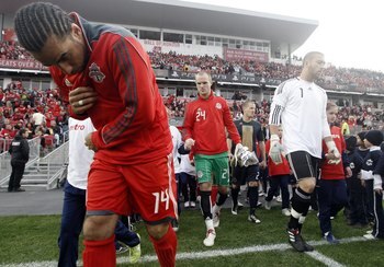 TORONTO - APRIL 15: Newly named captain Dwayne DeRosario #14 of Toronto FC takes to the new grass fiels before playing Philadelphia Union during action at BMO Field April 15, 2010 in Toronto, Ontario, Canada. (Photo by Abelimages/Getty Images)