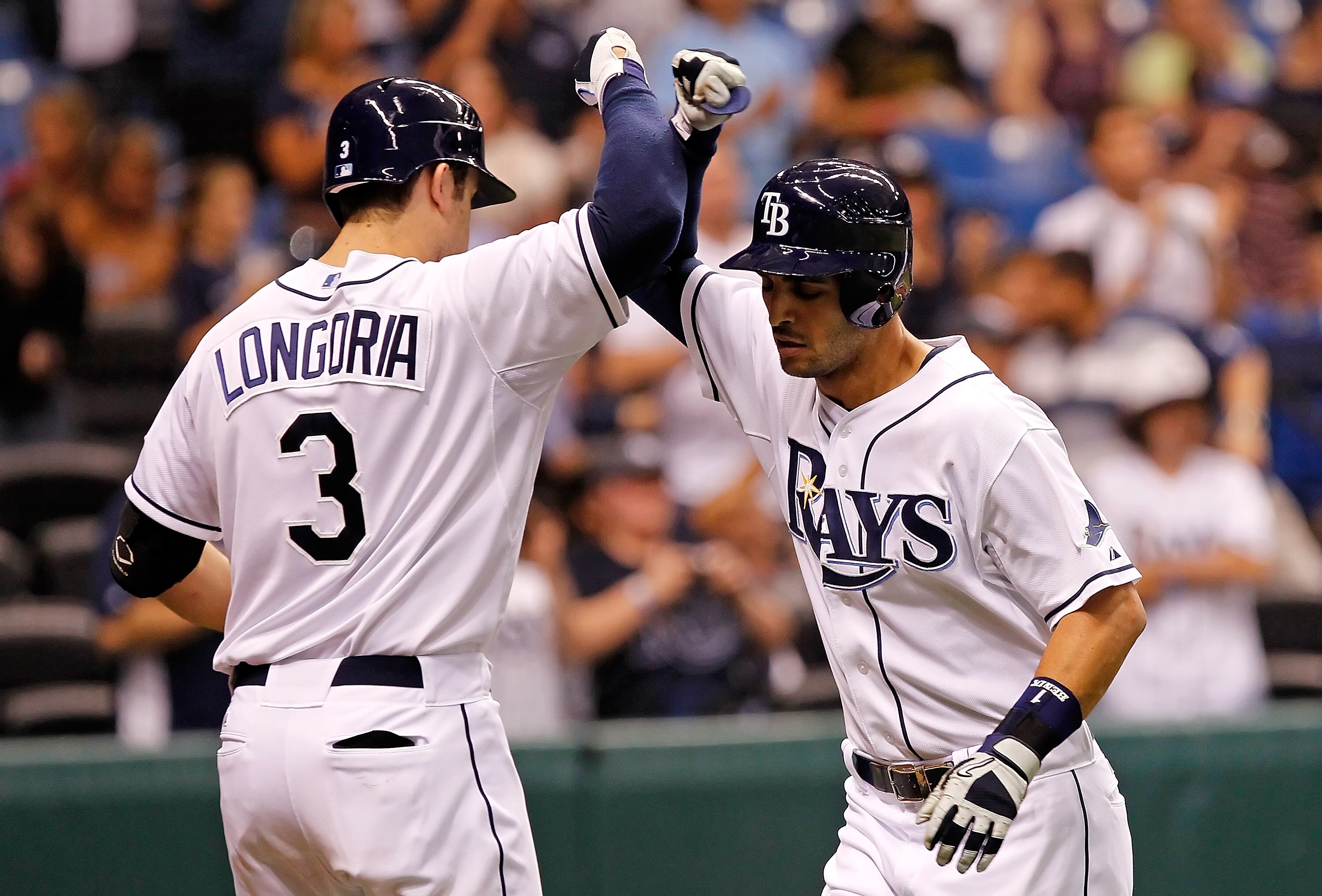 ST. PETERSBURG, FL - MAY 31:  Infielder Evan Longoria #3 of the Tampa Bay Rays congratulates infielder Sean Rodriguez #1 after his home run against the Texas Rangers during the game at Tropicana Field on May 31, 2011 in St. Petersburg, Florida.  (Photo by