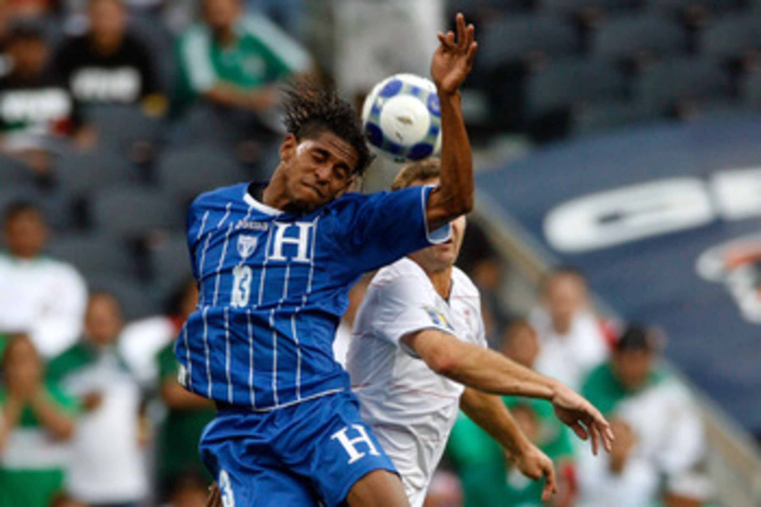 CHICAGO - JULY 23:  Carlo Costly #13 of Honduras heads the ball against the USA during their CONCACAF Cup Semifinal match at Soldier Field on July 23, 2009 in Chicago, Illinois.  (Photo by Brian Kersey/Getty Images)