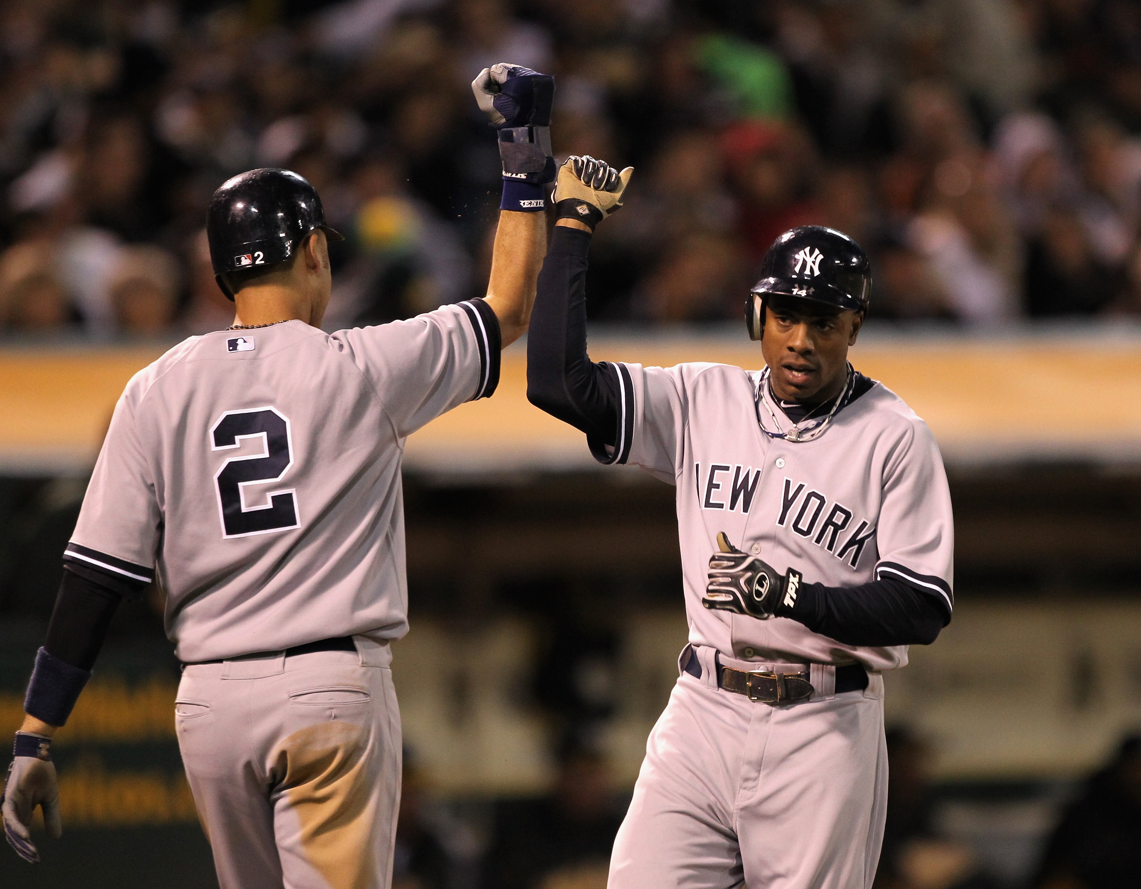 OAKLAND, CA - MAY 31:  Derek Jeter #2 and Curtis Granderson #14 of the New York Yankees congratulate one another after they scored on a single by Alex Rodriguez #13 of the New York Yankees in the sixth inning against the the Oakland Athletics at Oakland-A