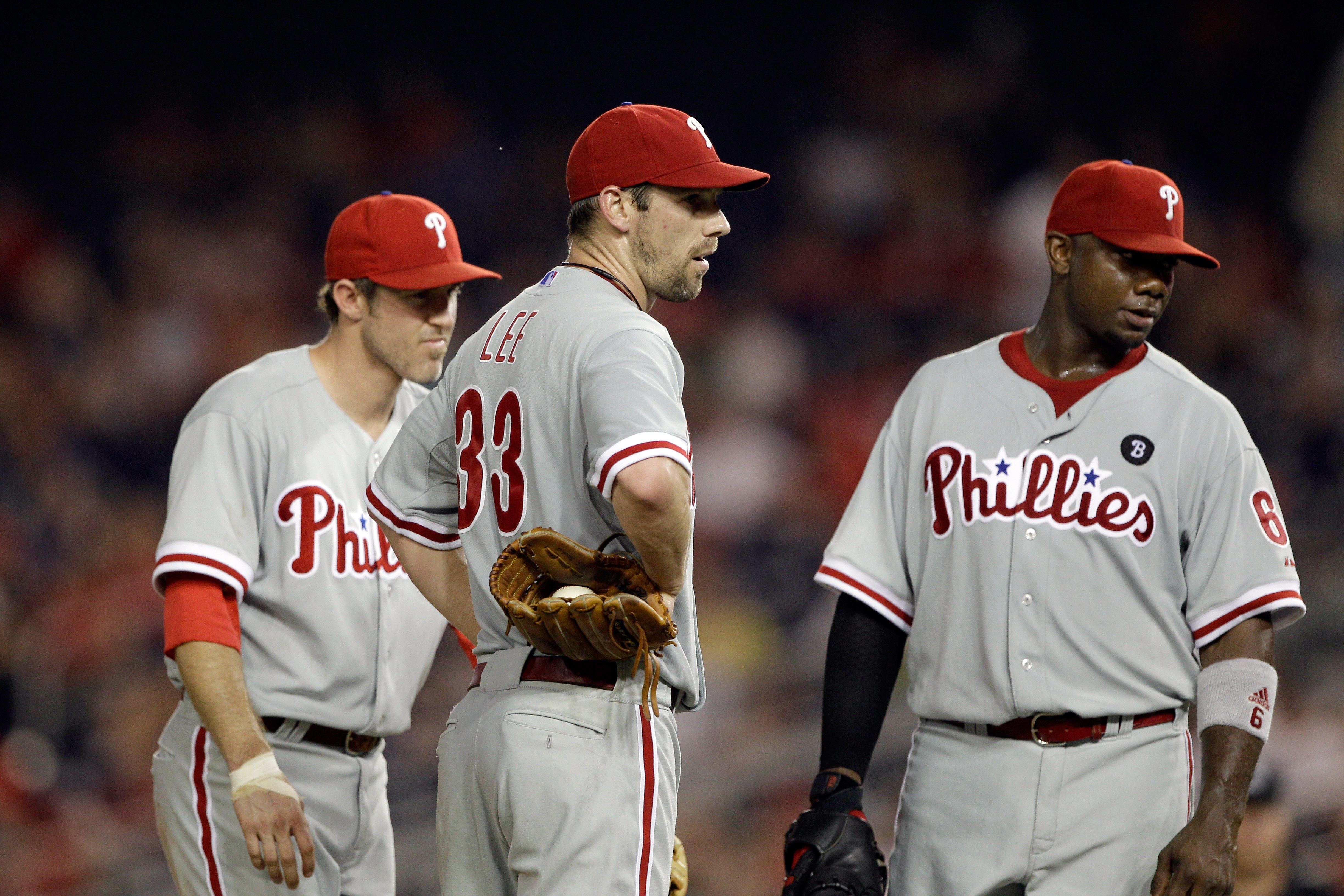 WASHINGTON, DC - MAY 31:  Second baseman Chase Utley #26 of the Philadelphia Phillies (L) talks with pitcher Cliff Lee #33 (C) and first baseman Ryan Howard #6 (R) during a pitching change against the Washington Nationals at Nationals Park on May 31, 2011