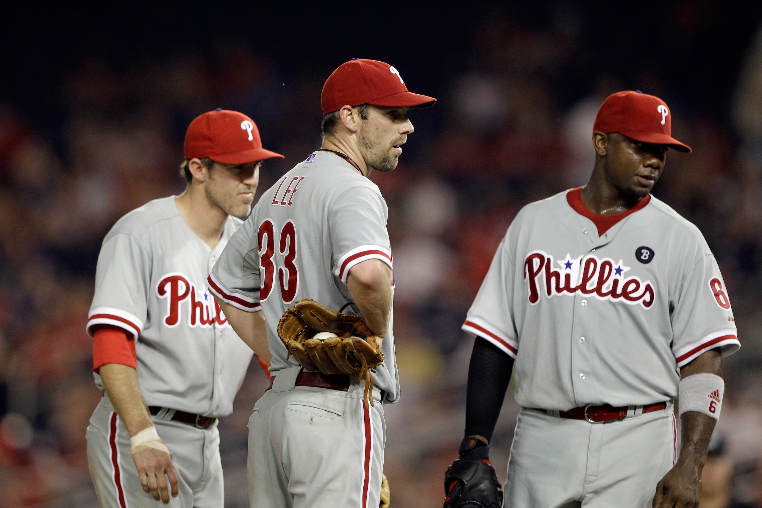 WASHINGTON, DC - MAY 31:  Second baseman Chase Utley #26 of the Philadelphia Phillies (L) talks with pitcher Cliff Lee #33 (C) and first baseman Ryan Howard #6 (R) during a pitching change against the Washington Nationals at Nationals Park on May 31, 2011