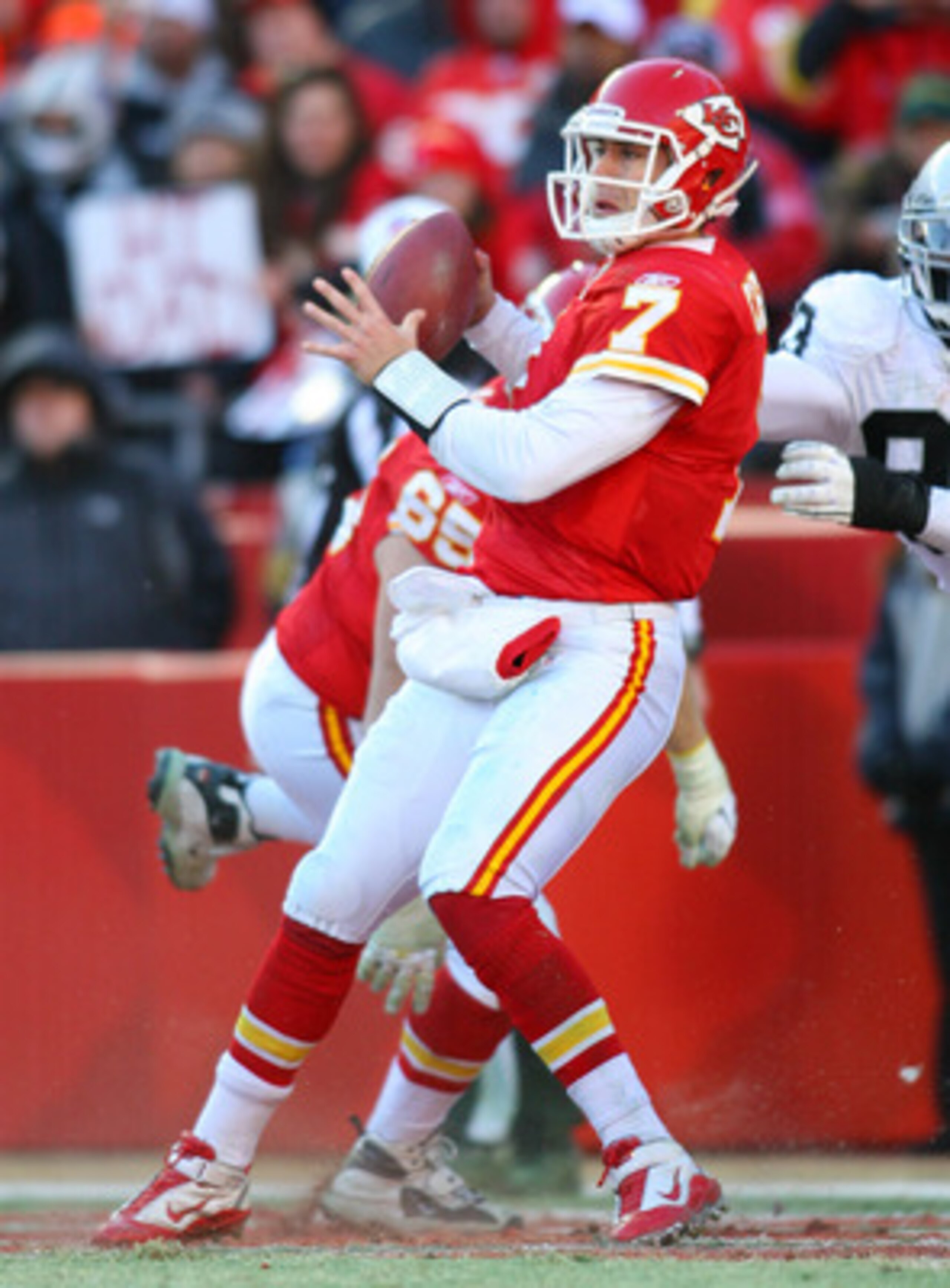 KANSAS CITY, MO - JANUARY 02:  Quarterback Matt Cassel #7 of the Kansas City Chiefs is hit as he throws by defensive tackle Tommy Kelly #93 of the Oakland Raiders in a game at Arrowhead Stadium on January 2, 2011 in Kansas City, Missouri.  (Photo by Tim U