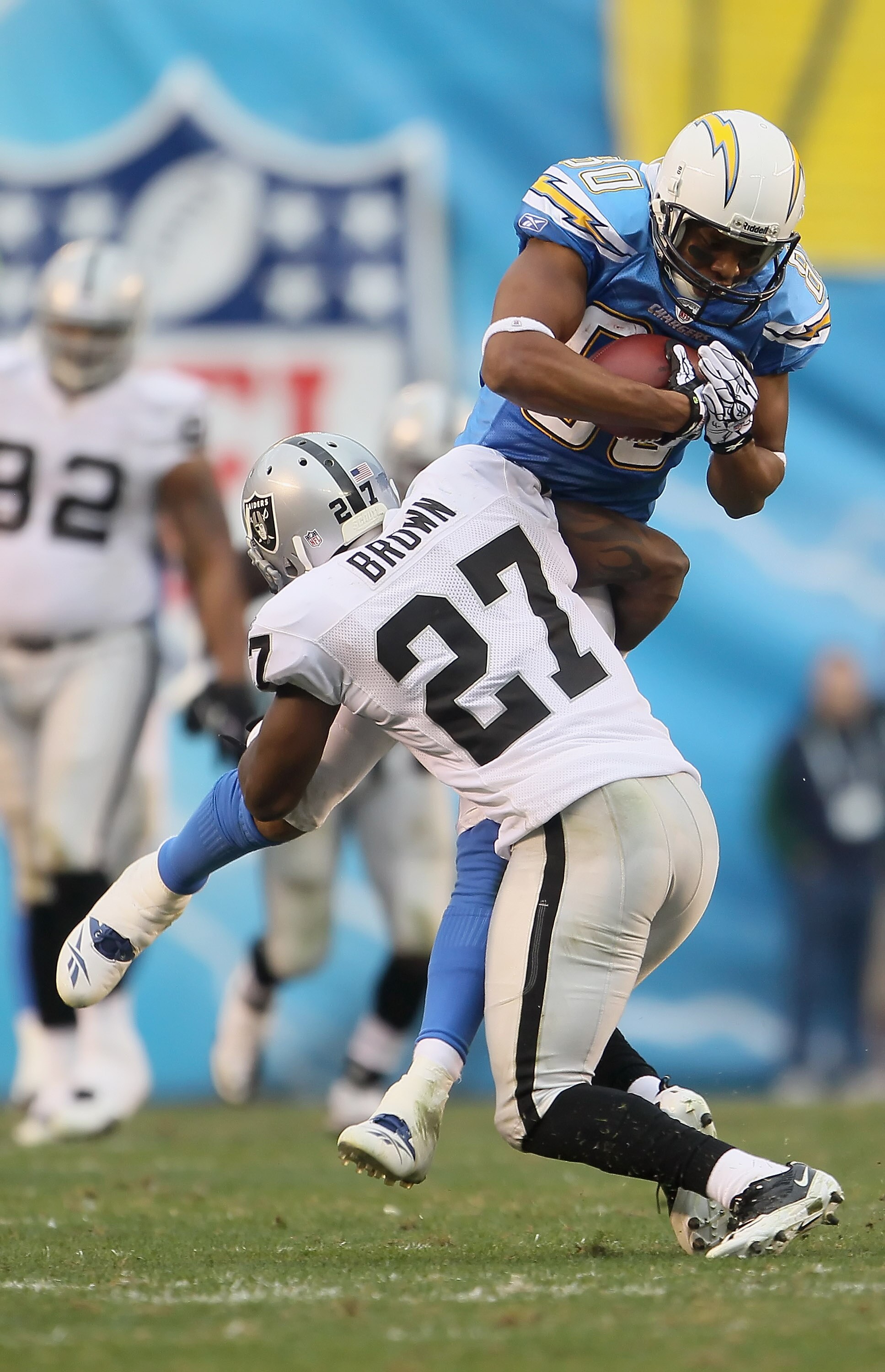SAN DIEGO - DECEMBER 05:  Wide receiver Malcolm Floyd #80 of the San Diego Chargers is tackled by Stevie Brown #27 of the Oakland Raiders in the third quarter at Qualcomm Stadium on December 5, 2010 in San Diego, California. The Raiders defeated the Charg