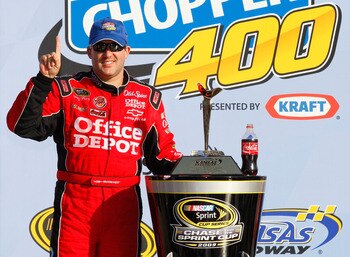 KANSAS CITY, KS - OCTOBER 04: Tony Stewart, driver of the #14 Office Depot/Old Spice Chevrolet, celebrates after winning the NASCAR Sprint Cup Series Price Chopper 400 presented by Kraft Foods at the Kansas Speedway on October 4, 2009 in Kansas City, Kans