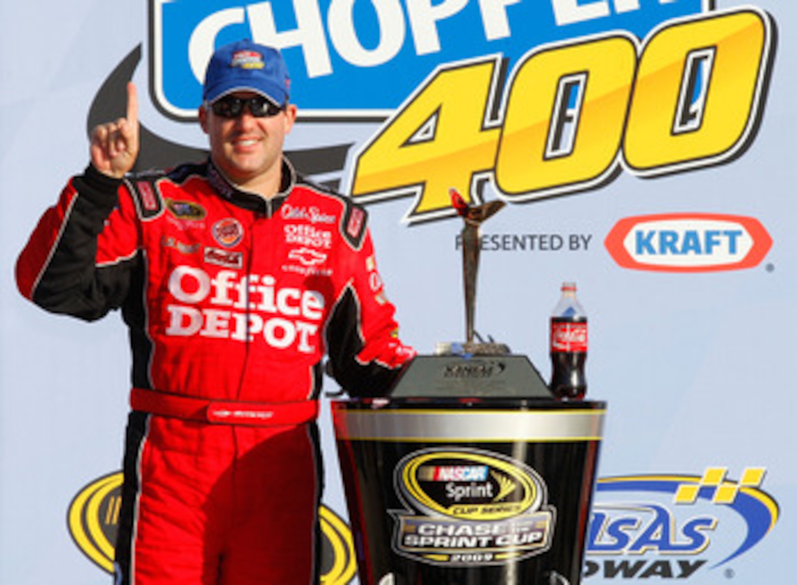 KANSAS CITY, KS - OCTOBER 04: Tony Stewart, driver of the #14 Office Depot/Old Spice Chevrolet, celebrates after winning the NASCAR Sprint Cup Series Price Chopper 400 presented by Kraft Foods at the Kansas Speedway on October 4, 2009 in Kansas City, Kans
