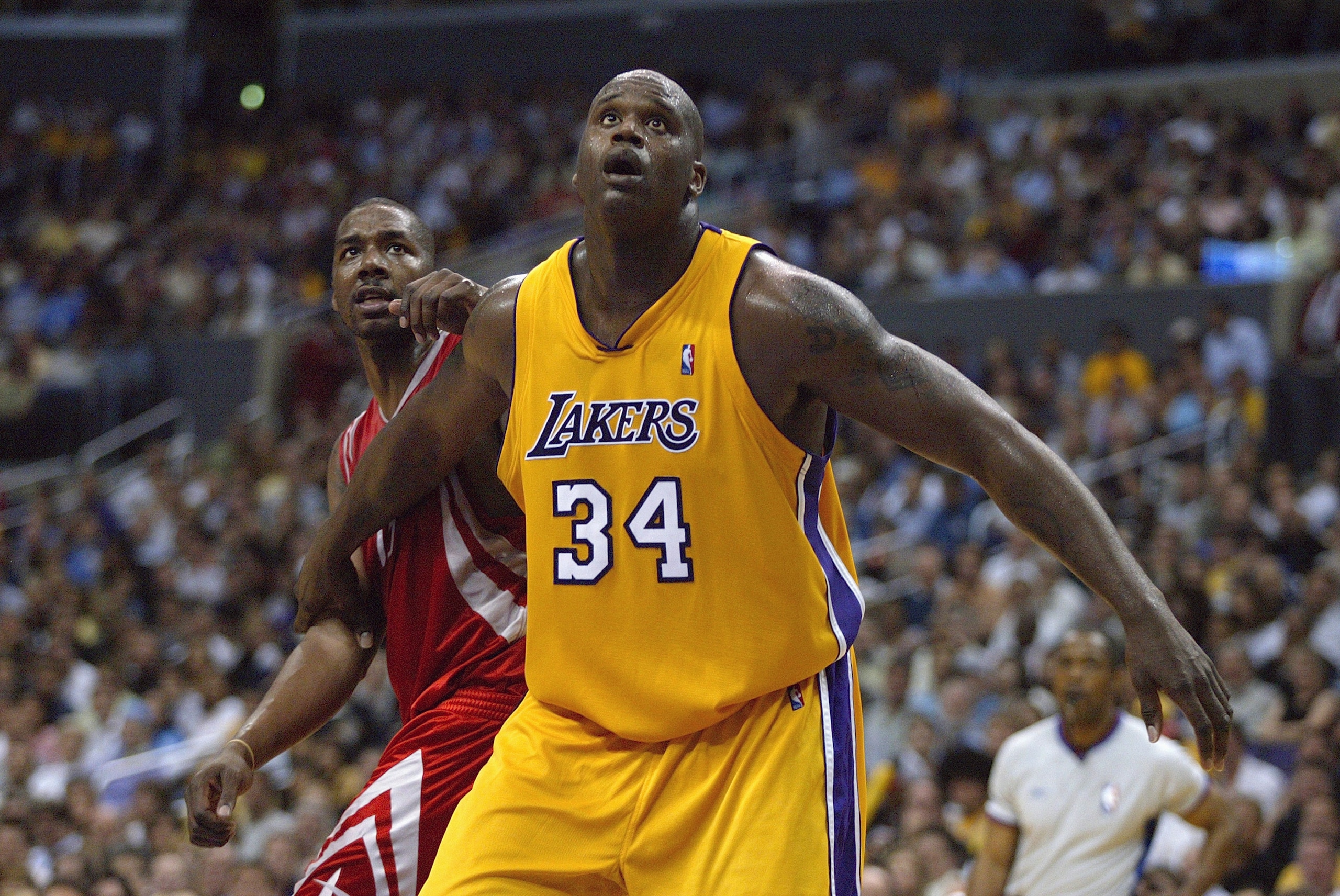 LOS ANGELES - APRIL 28: Shaquille O'Neal #34 of the Los Angeles Lakers boxes out Kelvin Cato #13 of the Houston Rockets during Game five of the Western Conference Quarterfinals during the 2004 NBA Playoffs at Staples Center on April 28, 2004 in Los Angel LOS ANGELES - APRIL 28: Shaquille O'Neal #34 of the Los Angeles Lakers boxes out Kelvin Cato #13 of the Houston Rockets during Game five of the Western Conference Quarterfinals during the 2004 NBA Playoffs at Staples Center on April 28, 2004 in Los Angel