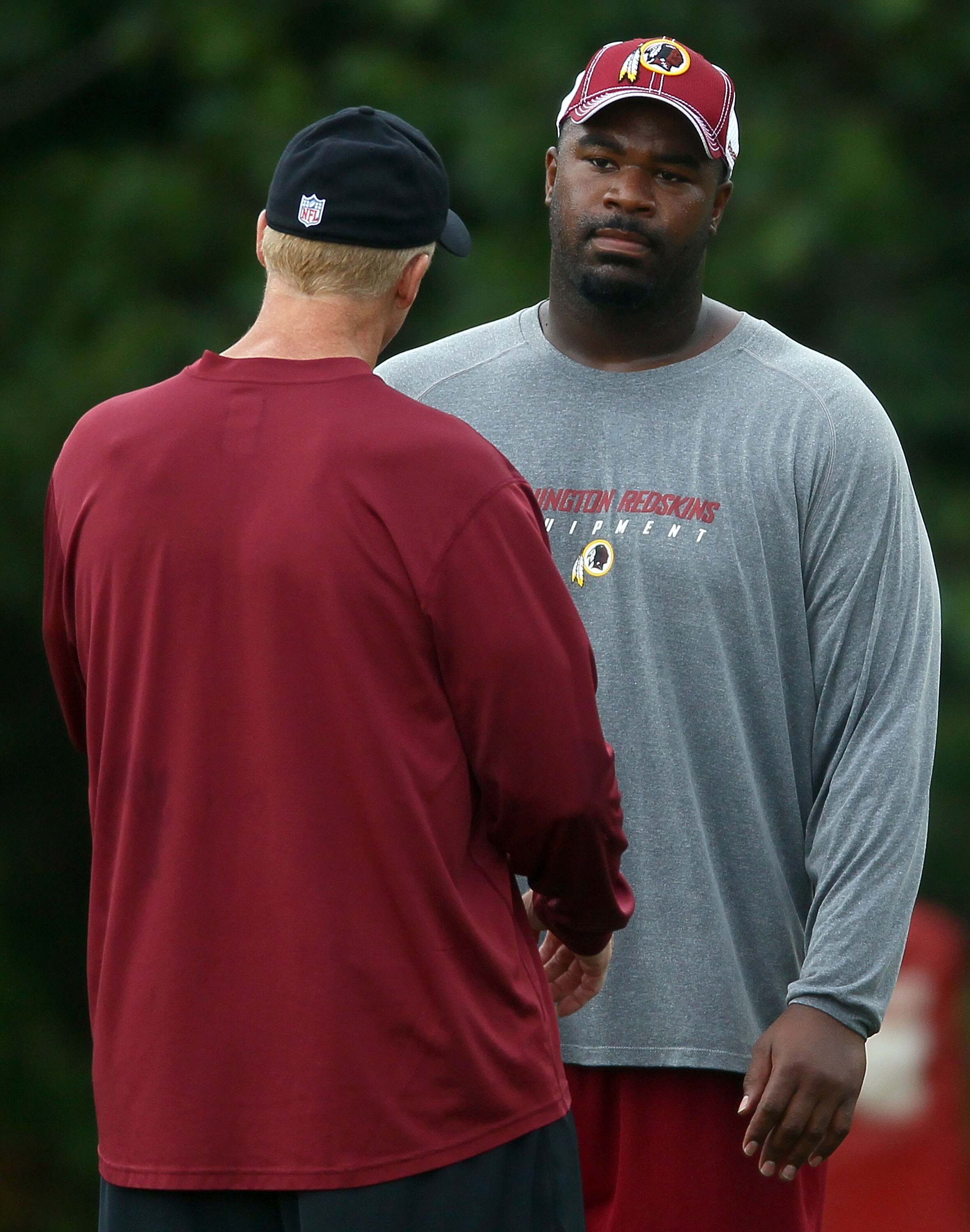 ASHBURN, VA - JULY 29:  Defensive lineman Albert Haynesworth #92 (R) works out with Defensive Coordinator Jim Haslett (L) after the Redskins first day of training camp on July 29, 2010 in Ashburn, Virginia.  (Photo by Win McNamee/Getty Images)