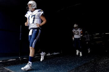 DENVER, CO - JANUARY 2:  Quarterback Philip Rivers #17 of the San Diego Chargers leads teammates center Scott Mruczkowski #63 and quarterback Billy Volek #7 out of the tunnel before a game against the Denver Broncos at INVESCO Field at Mile High on Januar