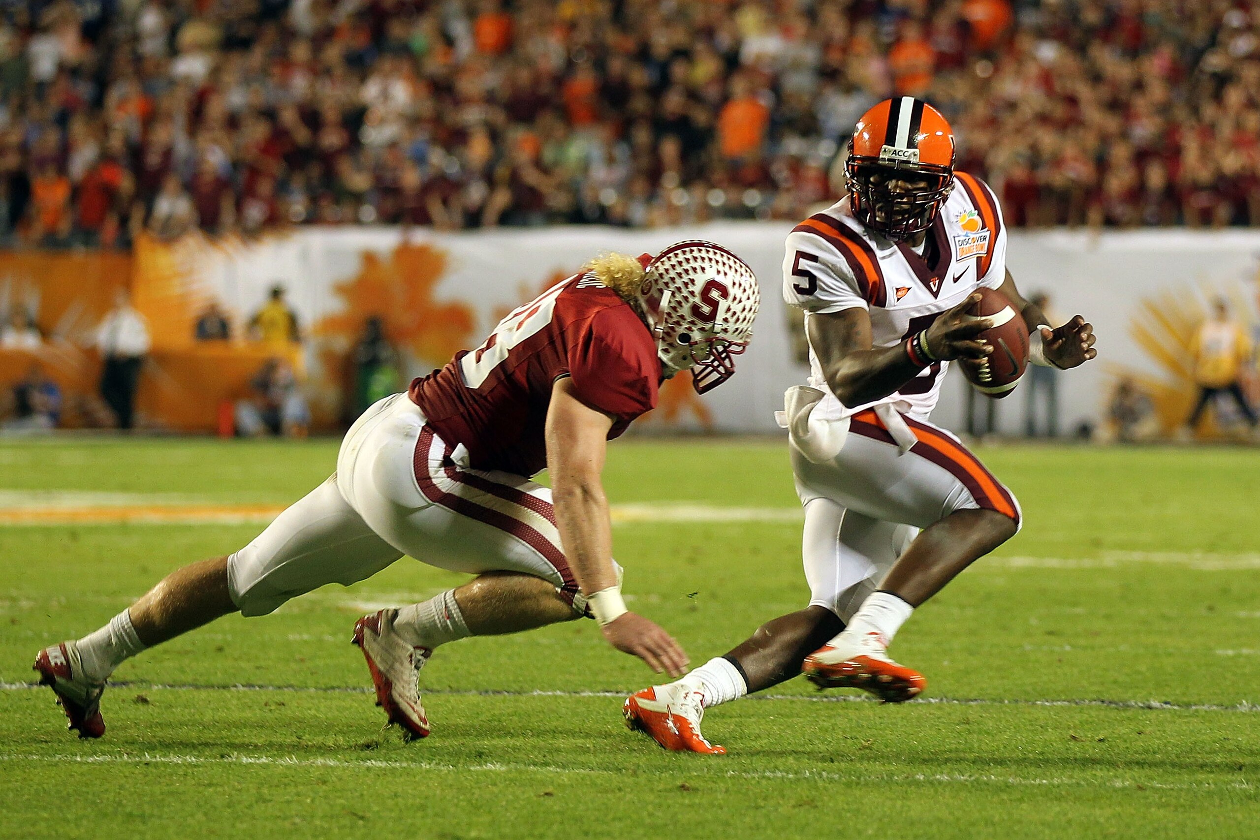 MIAMI, FL - JANUARY 03:  Tyrod Taylor #5 of the Virginia Tech Hokies attempts to avoid the pass rush by Owen Marecic #48 of the Stanford Cardinal during the 2011 Discover Orange Bowl at Sun Life Stadium on January 3, 2011 in Miami, Florida. Stanford won 4