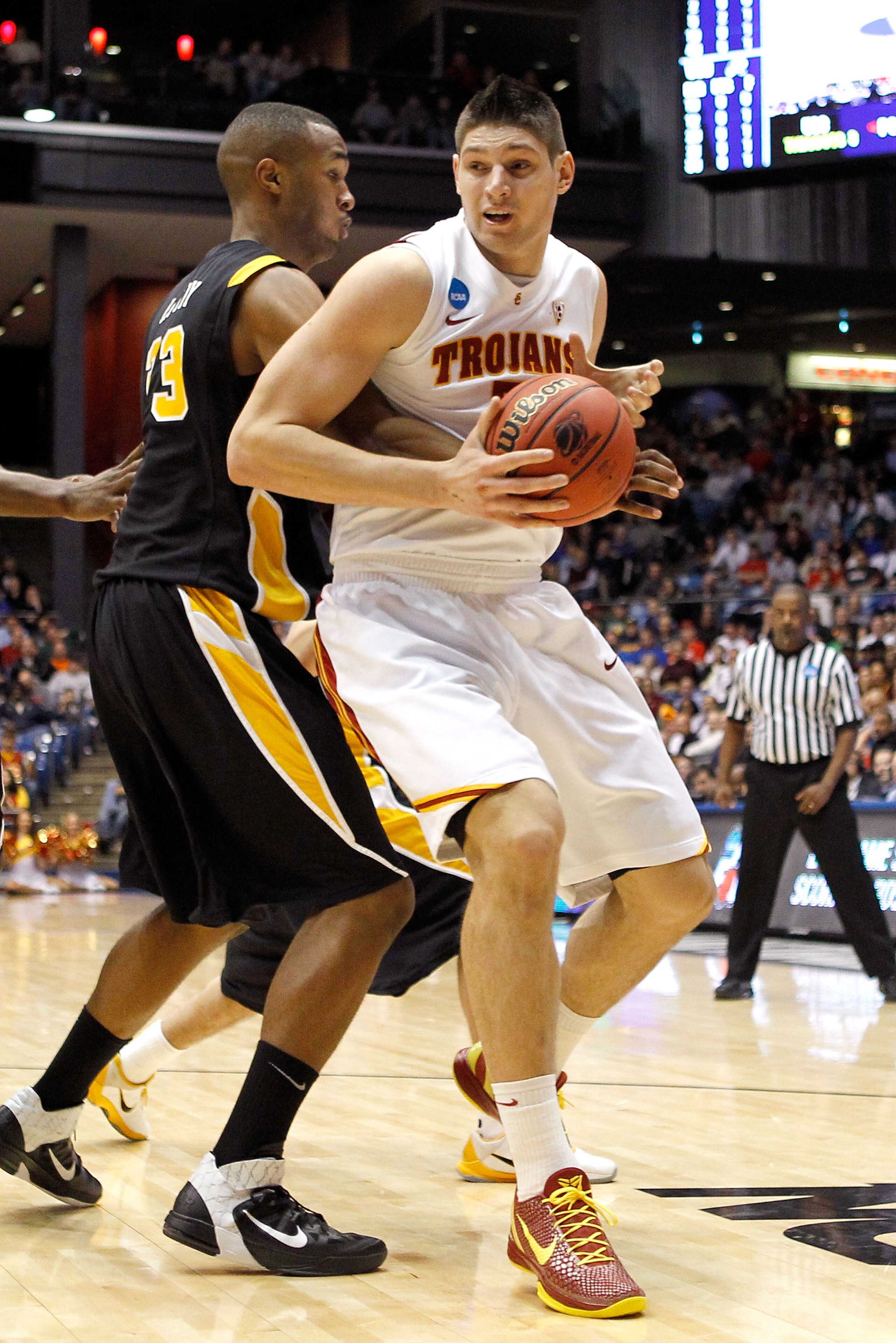 DAYTON, OH - MARCH 16: Nikola Vucevic #5 of the USC Trojans handles the ball against D.J. Haley #33 of the Virginia Commonwealth Rams during the first round of the 2011 NCAA men's basketball tournament at UD Arena on March 16, 2011 in Dayton, Ohio. (Phot DAYTON, OH - MARCH 16: Nikola Vucevic #5 of the USC Trojans handles the ball against D.J. Haley #33 of the Virginia Commonwealth Rams during the first round of the 2011 NCAA men's basketball tournament at UD Arena on March 16, 2011 in Dayton, Ohio. (Phot