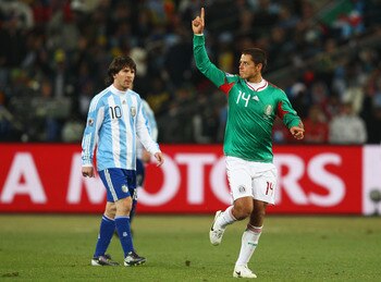 JOHANNESBURG, SOUTH AFRICA - JUNE 27: Javier Hernandez of Mexico celebrates scoring his team's first goal as Lionel Messi of Argentina looks on during the 2010 FIFA World Cup South Africa Round of Sixteen match between Argentina and Mexico at Soccer City 