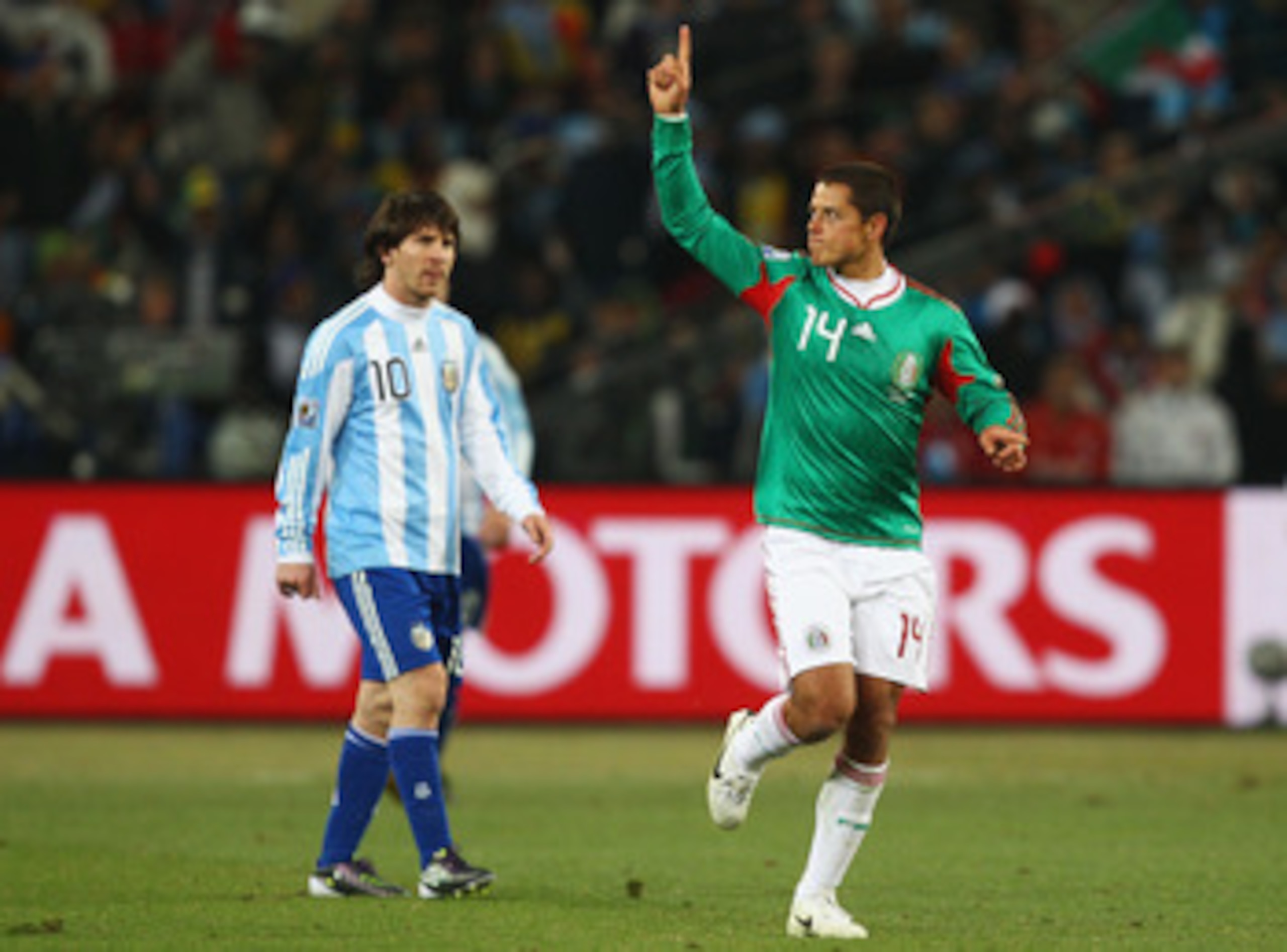 JOHANNESBURG, SOUTH AFRICA - JUNE 27: Javier Hernandez of Mexico celebrates scoring his team's first goal as Lionel Messi of Argentina looks on during the 2010 FIFA World Cup South Africa Round of Sixteen match between Argentina and Mexico at Soccer City 