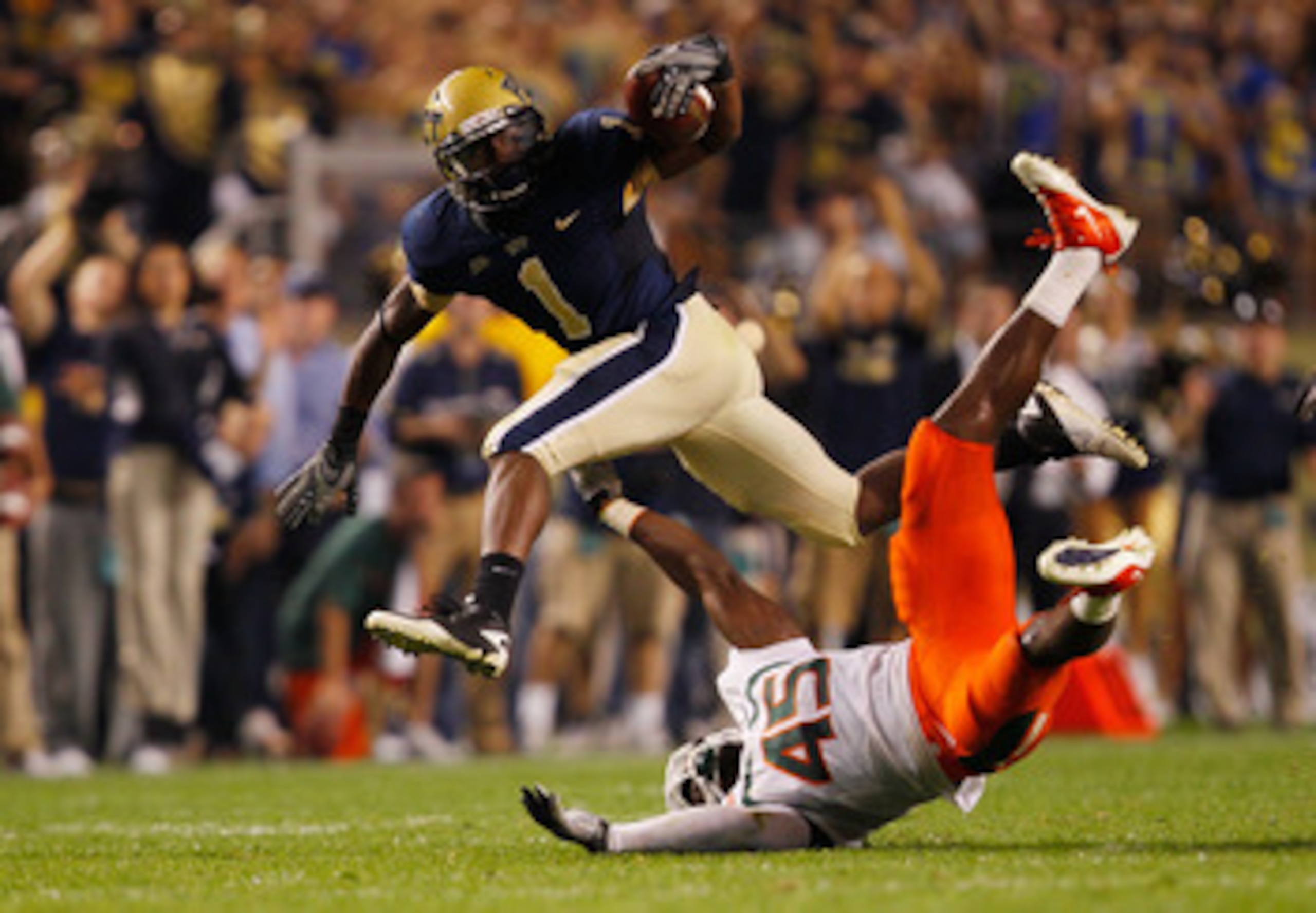 PITTSBURGH - SEPTEMBER 23:  Ray Graham #1 of the Pittsburgh Panthers evades a tackle by Ramon Buchanan #45 of the Miami Hurricanes on September 23, 2010 at Heinz Field in Pittsburgh, Pennsylvania.  (Photo by Jared Wickerham/Getty Images)