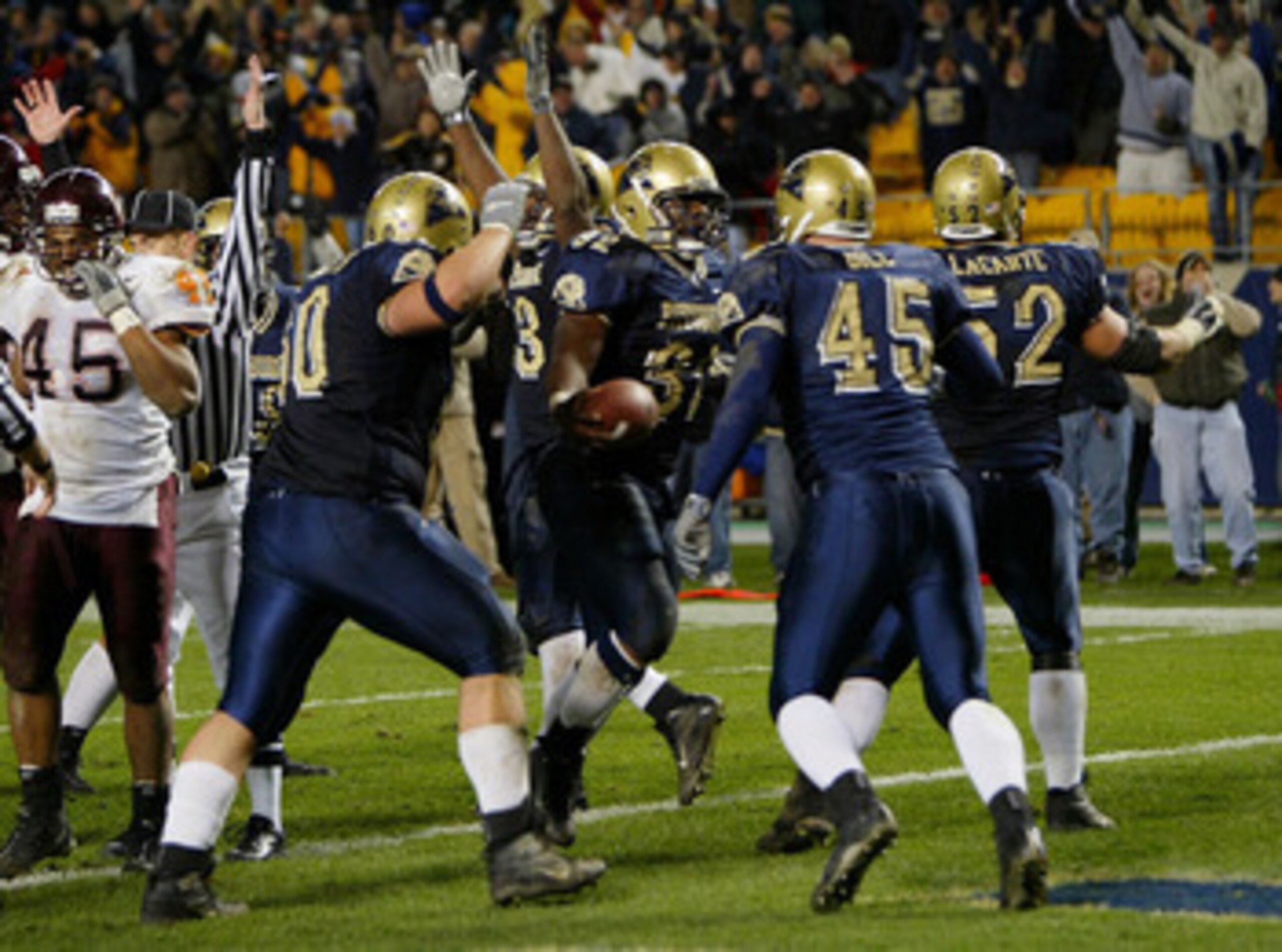 PITTSBURGH - NOVEMBER 8:  Lousaka Polite #32 of the University of Pittsburgh Panthers celebrates with his teammates after he scored the game winning touchdown in the final minute as the Panthers defeated the Virginia Tech Hokies 31-28 during NCAA football