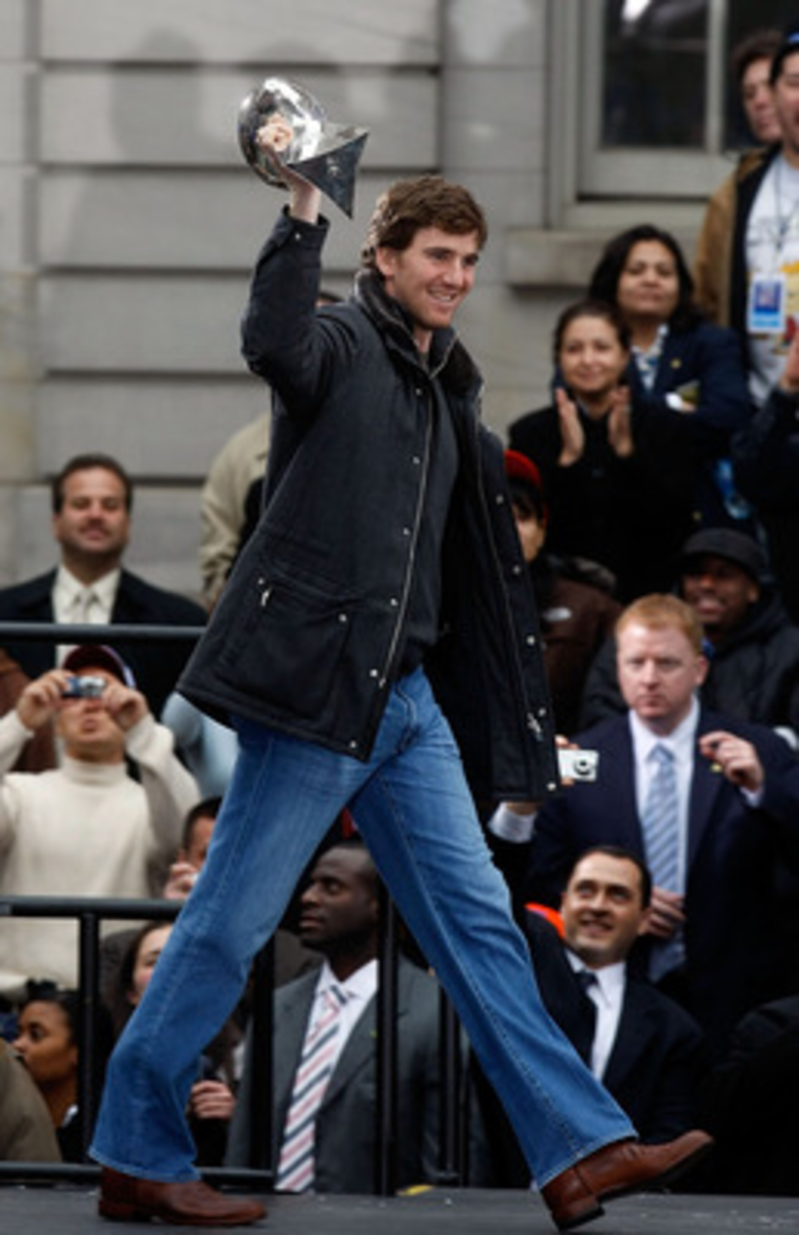 NEW YORK - FEBRUARY 05:  Quarterback Eli Manning holds the Vince Lombardi trophy up as he takes the stage during the New York Giants Super Bowl XLII victory parade reception at City Hall February 5, 2008 in New York City.  (Photo by Nick Laham/Getty Image