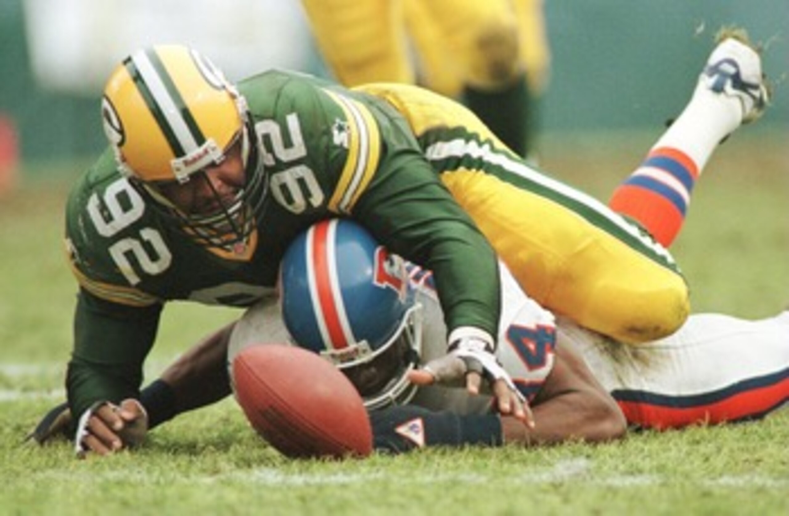 8 Dec 1996:  Defensive end Reggie White #92 of the Green Bay Packers scrambles over wide receiver Shannon Sharpe #84 of the Denver Broncos for quarterback Bill Musgrave''s fumble in the fourth quarter of their game at Lambeau Field in Green Bay, Wisconsin