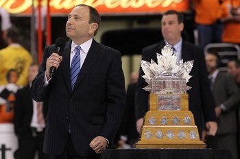 PHILADELPHIA - JUNE 09:  NHL Commissioner Gary Bettman presents the Conn Smythe Trophy to Jonathan Toews #19 of the Chicago Blackhawks after the Blackhawks defeated the Philadelphia Flyers 4-3 in overtime to win the Stanley Cup in Game Six of the 2010 NHL