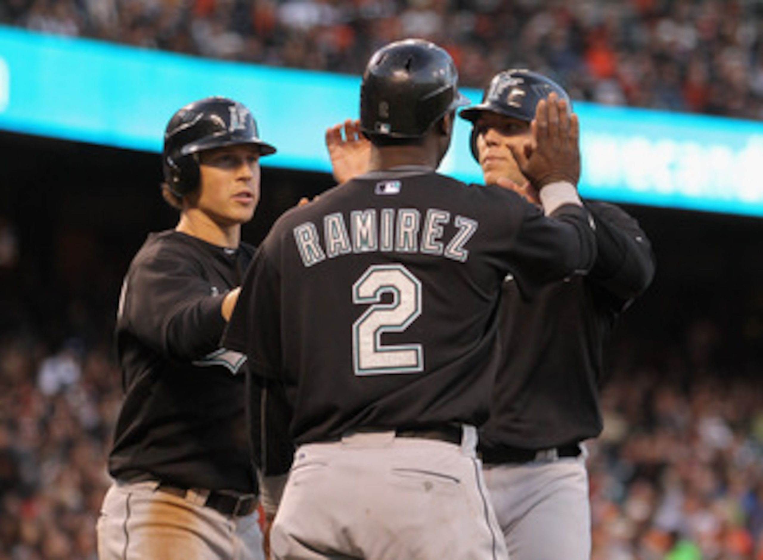 SAN FRANCISCO, CA - MAY 24:  (from left) Chris Coghlan #8, Hanley Ramirez #2 and Logan Morrison #20 of the Florida Marlins celebrate after they all scored on a double by Gaby Sanchez #15 of the Florida Marlins in the third inning against the San Francisco