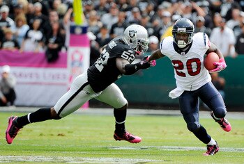 OAKLAND, CA - OCTOBER 3: Running back Steve Slaton #20 of the Houston Texans pushes away from linebacker Quentin Groves #52 of the Oakland Raiders during an NFL football game October 3, 2010 at The Oakland-Alameda County Coliseum in Oakland, California.  