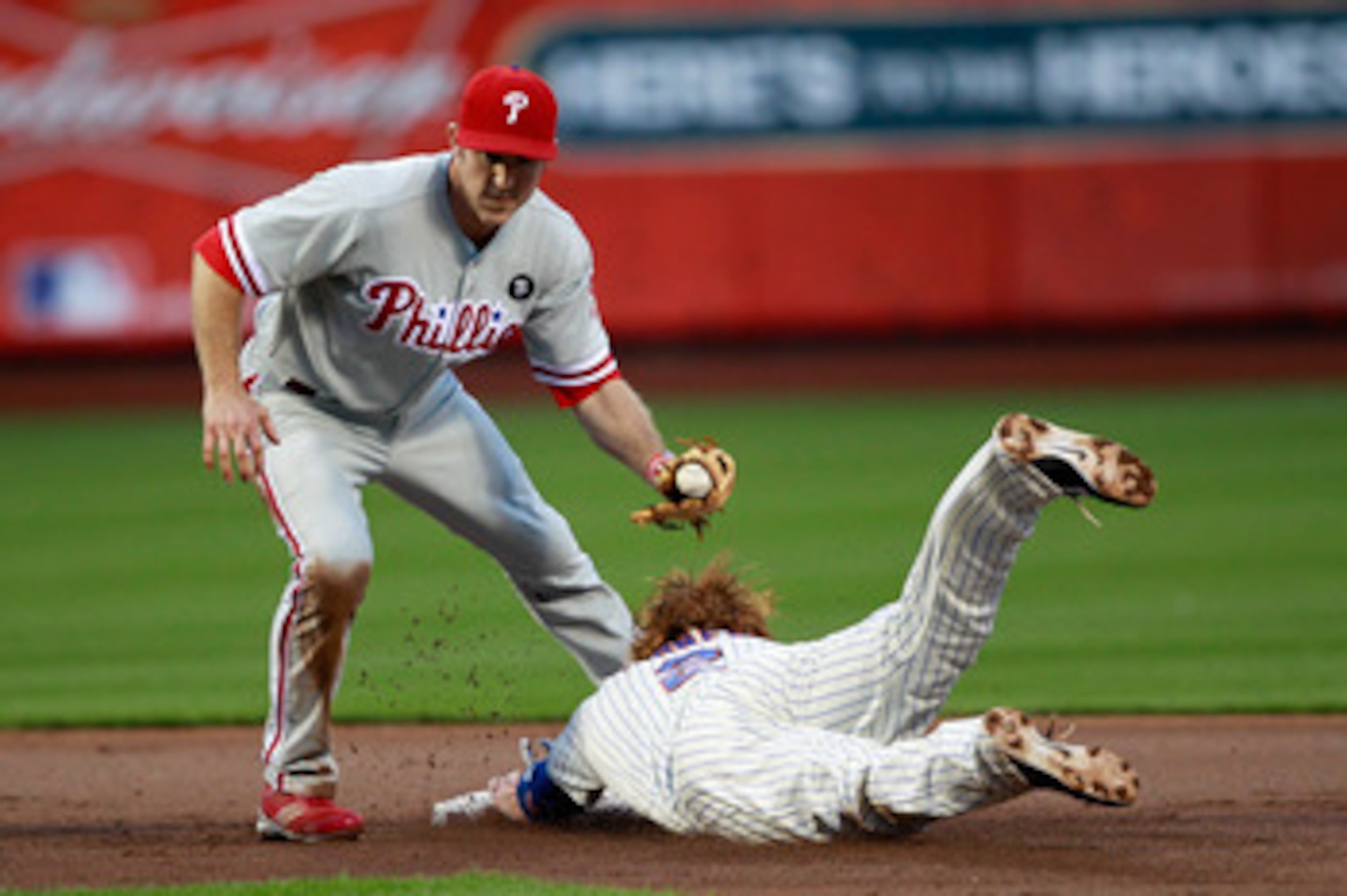 NEW YORK, NY - MAY 28: Justin Turner #2 of the New York Mets steals second base in front of Chase Utley #26 of the Philadelphia Phillies at Citi Field on May 28, 2011 in the Flushing neighborhood of the Queens borough of New York City.  (Photo by Chris Tr