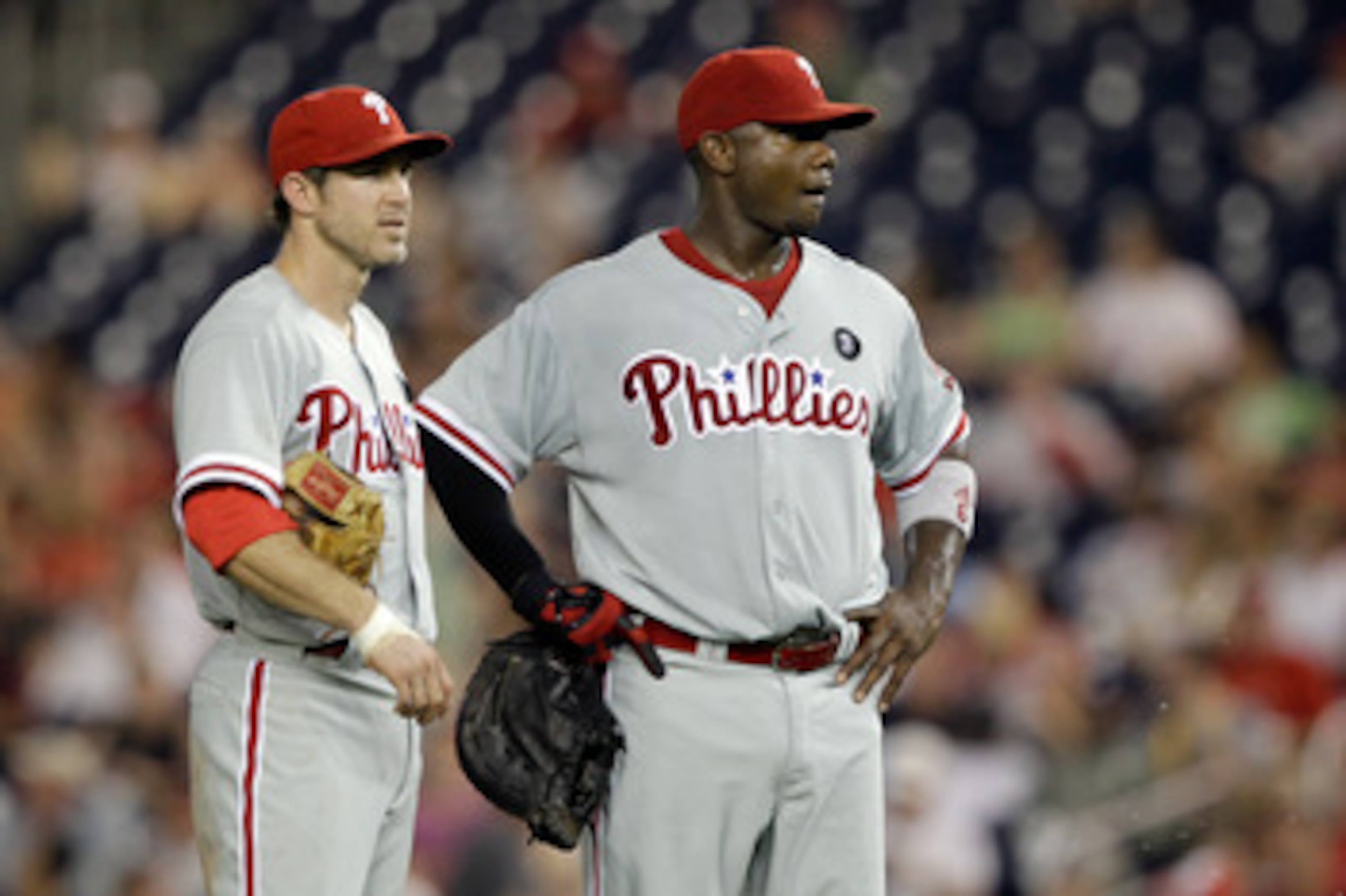 WASHINGTON, DC - MAY 31: Chase Utley #26 of the Philadelphia Phillies and Ryan Howard #6 talk between innings against the Washington Nationals  at Nationals Park on May 31, 2011 in Washington, DC. The Braves won 2-0. (Photo by Rob Carr/Getty Images)