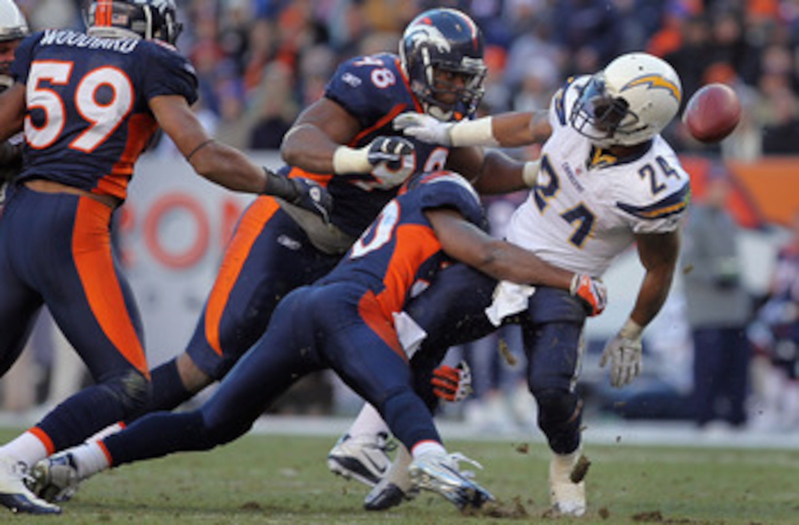 DENVER - JANUARY 02:  Running back Ryan Mathews #24 of the San Diego Chargers fumbles the ball as he is tackled by Brian Dawkins #20 of the Denver Broncos at INVESCO Field at Mile High on January 2, 2011 in Denver, Colorado. The ball was recovered by Kris