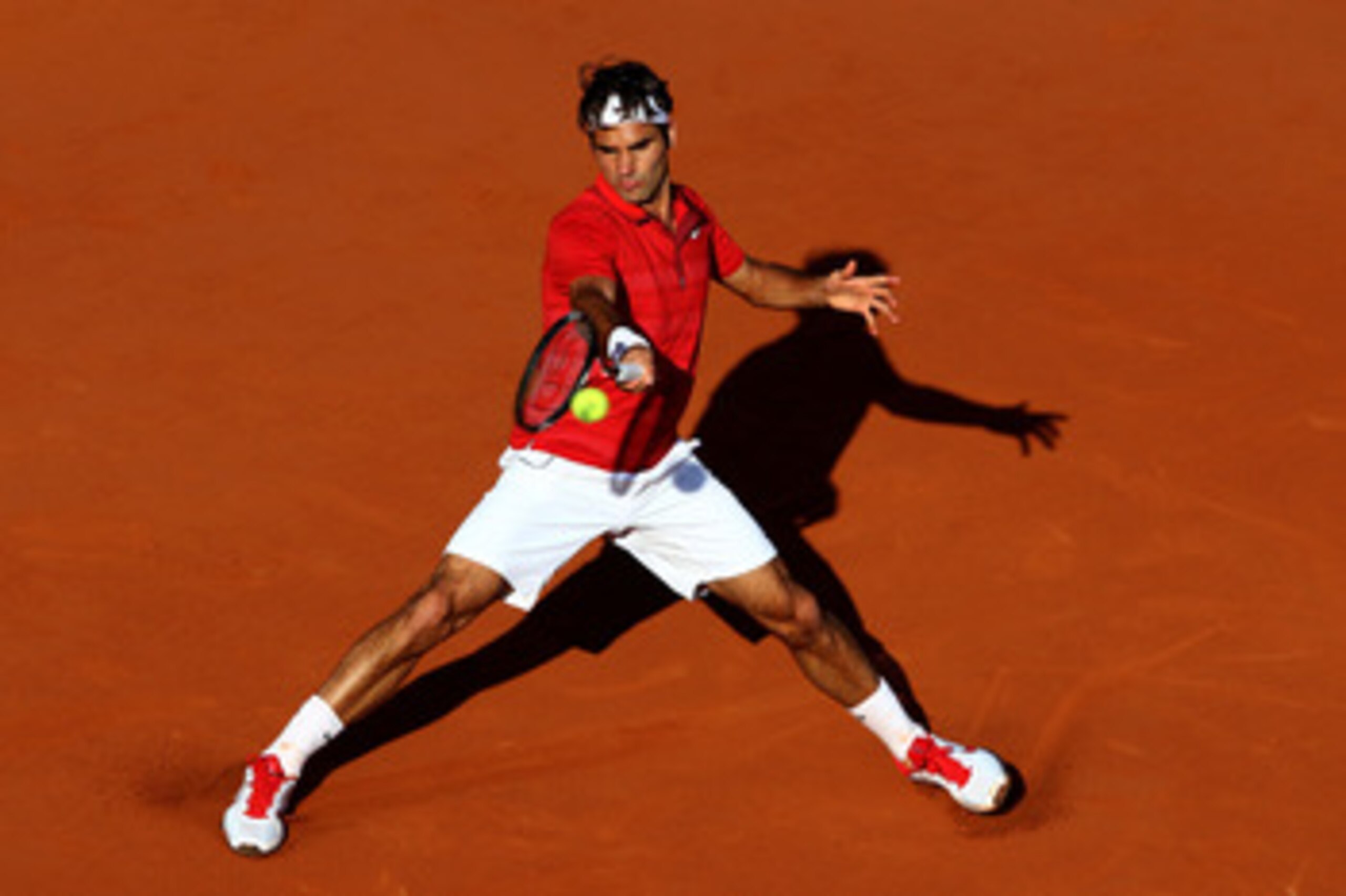 PARIS, FRANCE - MAY 31:  Roger Federer of Switzerland hits a forehand during the men's singles quarterfinal match between Gael Monfils of France and Roger Federer of Switzerland on day ten of the French Open at Roland Garros on May 31, 2011 in Paris, Fran