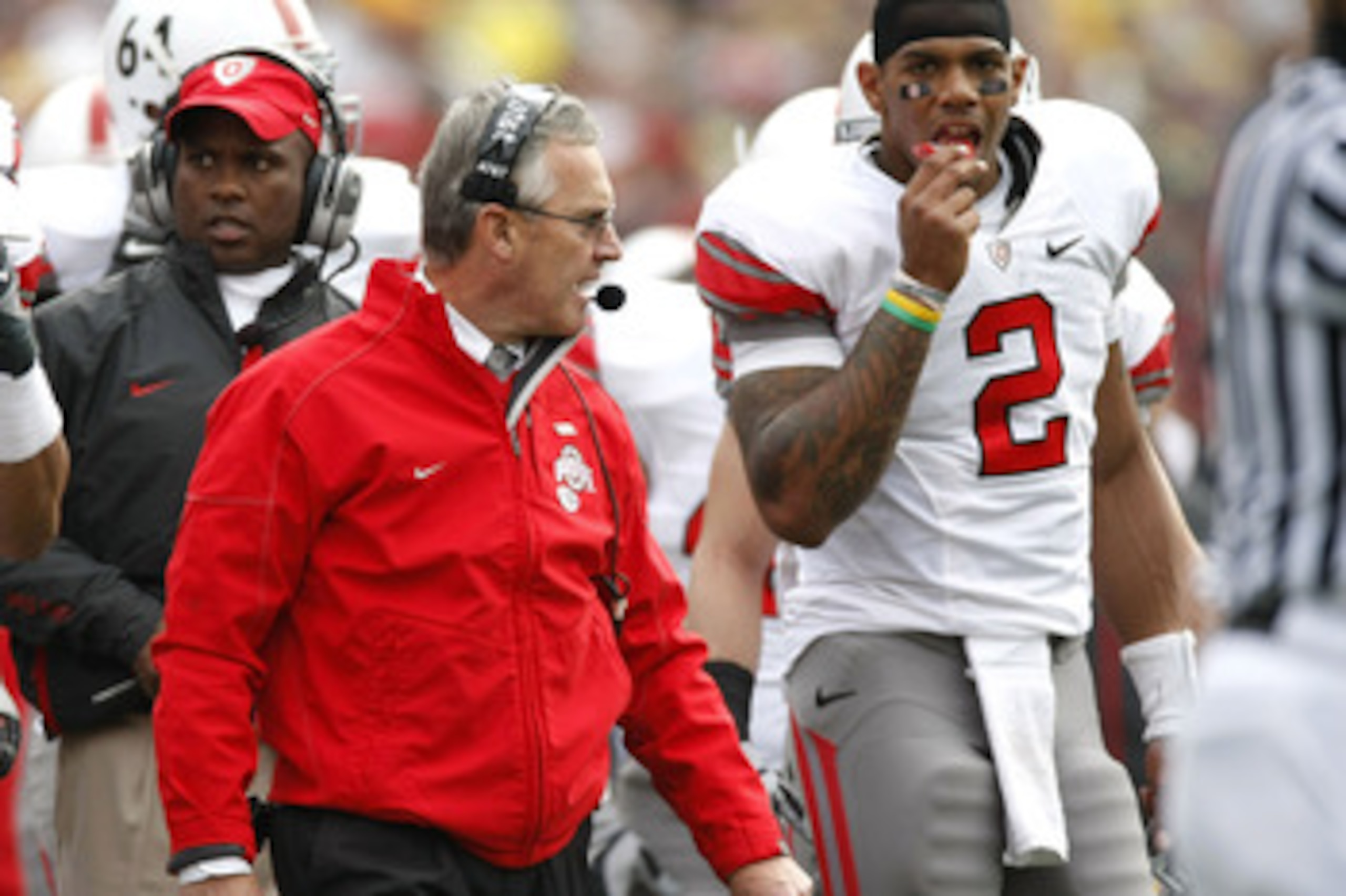ANN ARBOR, MI - NOVEMBER 21: Head coach Jim Tressel of the Ohio State Buckeyes walks the sideline next to Terrelle Pryor #2 while playing the Michigan Wolverines on November 21, 2009 at Michigan Stadium in Ann Arbor, Michigan. Ohio State won the game 21-1