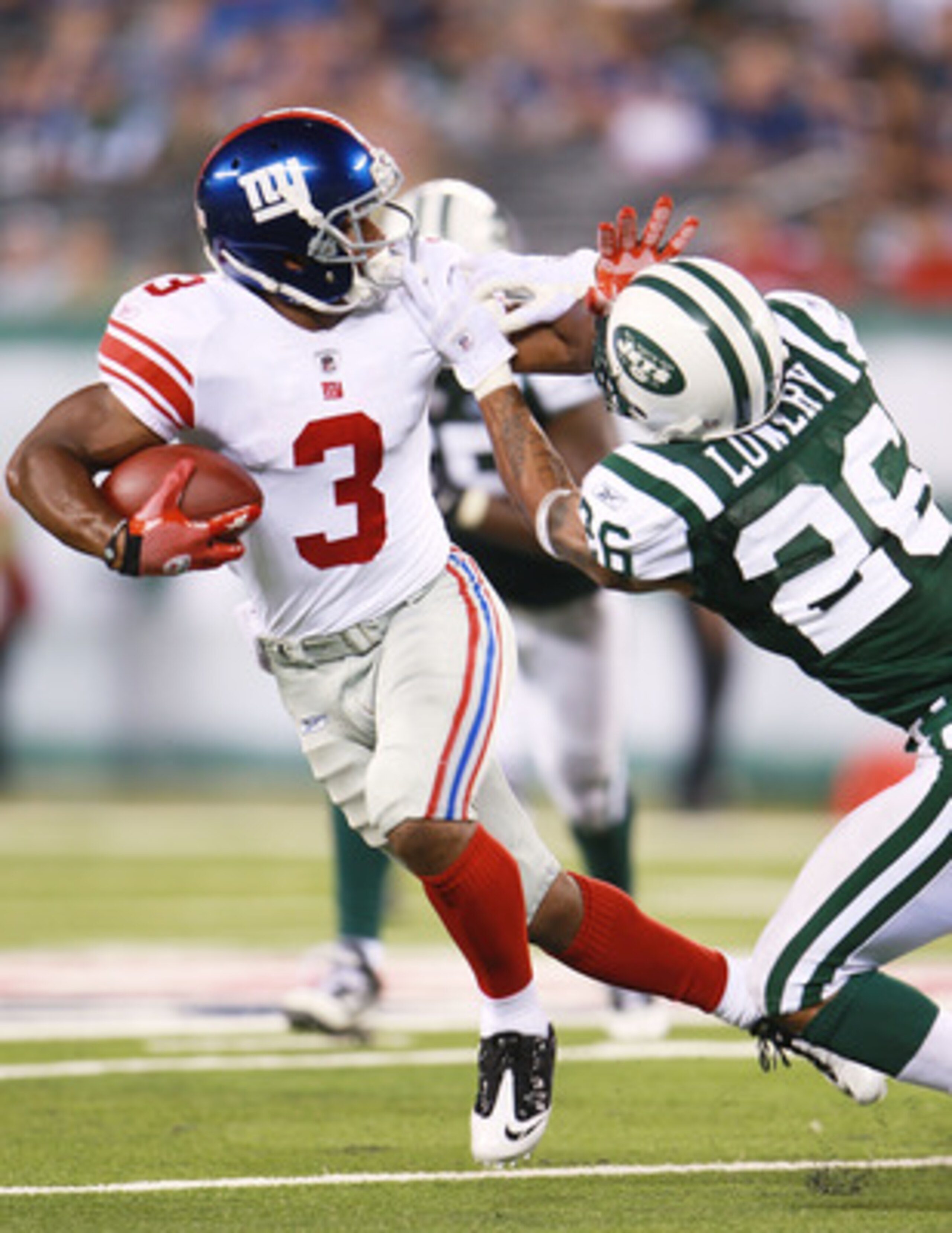 EAST RUTHERFORD, NJ - AUGUST 16: Victor Cruz #3 of the New York Giants breaks a tackle from Dwight Lowery #26 of the New York Jets during the preseason game at New Meadowlands Stadium on August 16, 2010 in East Rutherford, New Jersey. The Giants won 31 EAST RUTHERFORD, NJ - AUGUST 16: Victor Cruz #3 of the New York Giants breaks a tackle from Dwight Lowery #26 of the New York Jets during the preseason game at New Meadowlands Stadium on August 16, 2010 in East Rutherford, New Jersey. The Giants won 31