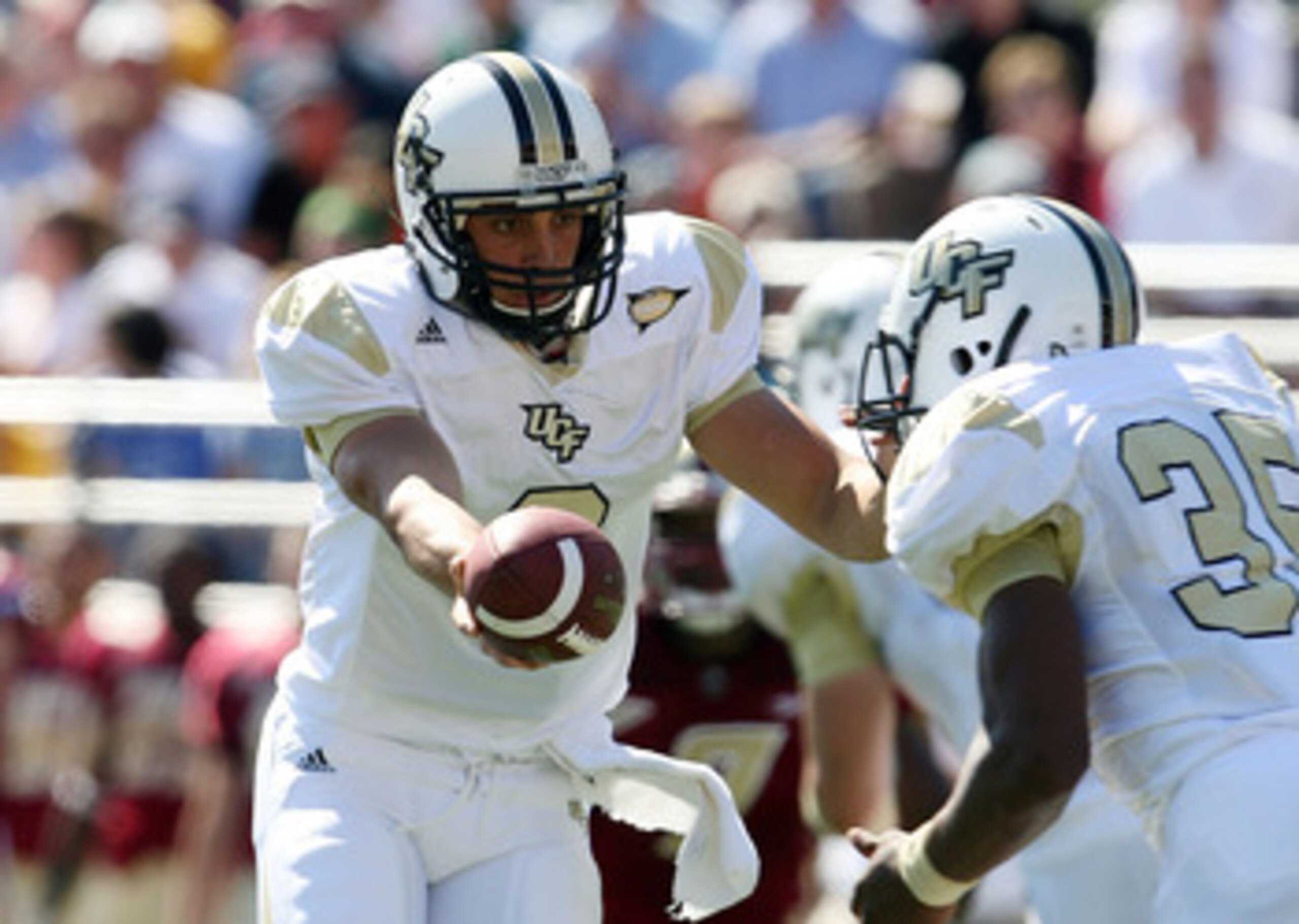 CHESTNUT HILL, MA - SEPTEMBER 20:  Michael Greco #2 of the Central Florida Knights hands the ball off to Ronnie Weaver #35 in the first half against the Boston College Eagles on September 20, 2008 at Alumni Stadium in Chestnut Hill, Massachusetts.  (Photo