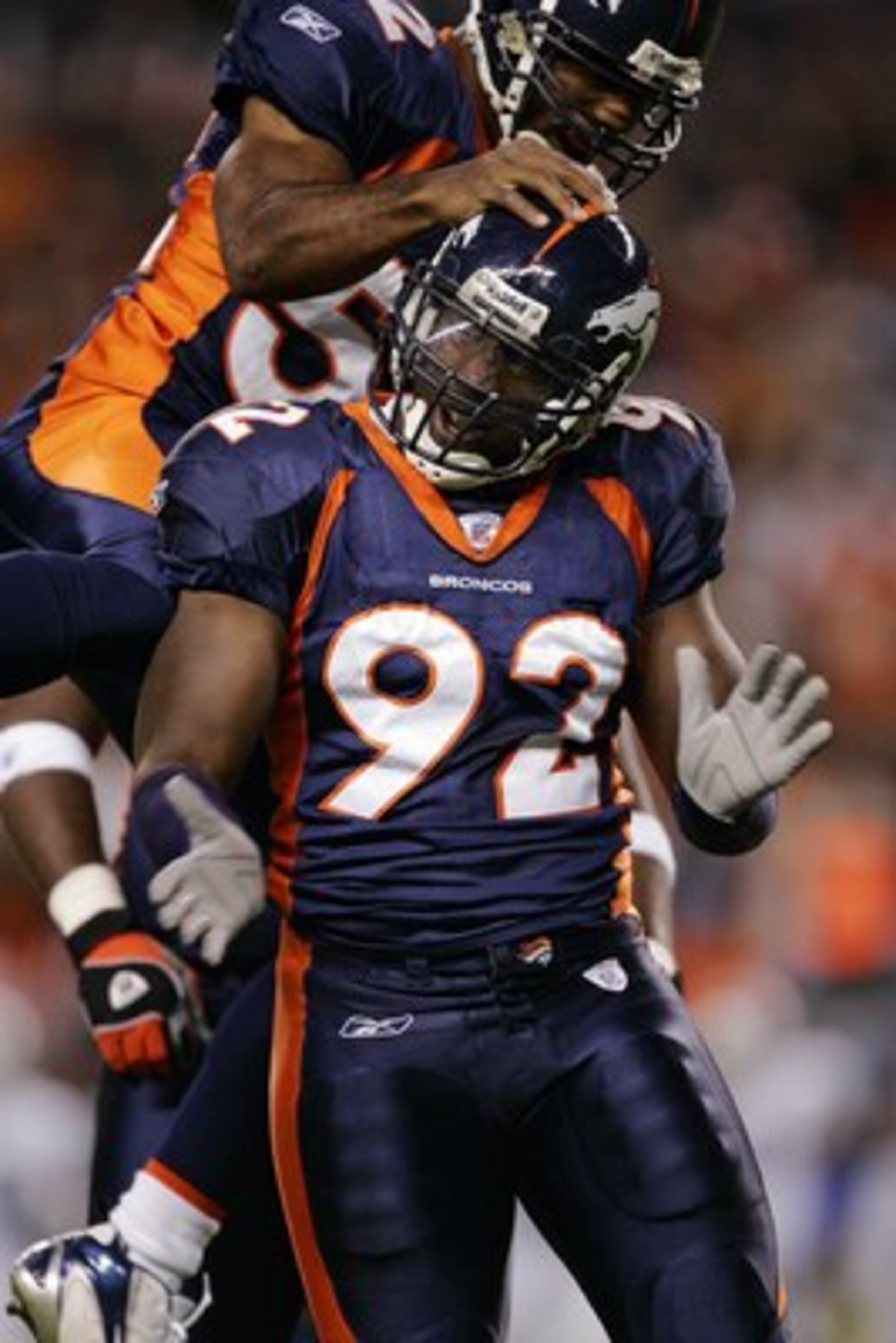 DENVER - OCTOBER 15: Defensive End Elvis Dumervil #92 of the Denver Broncos celebrates a sack on quarterback Andrew Walter of the Oakland Raiders with linebacker Ian Gold #52 in the first quarter on October 15, 2006 at Invesco Field at Mile High in Denve DENVER - OCTOBER 15: Defensive End Elvis Dumervil #92 of the Denver Broncos celebrates a sack on quarterback Andrew Walter of the Oakland Raiders with linebacker Ian Gold #52 in the first quarter on October 15, 2006 at Invesco Field at Mile High in Denve