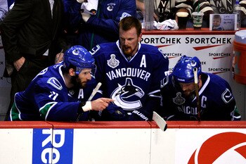 VANCOUVER, BC - JUNE 01:  (L-R) Ryan Kesler #17, Daniel Sedin #22 and Henrik Sedin #33 of the Vancouver Canucks talk on the bench during game one against the Boston Bruins in the 2011 NHL Stanley Cup Finals at Rogers Arena on June 1, 2011 in Vancouver, Ca