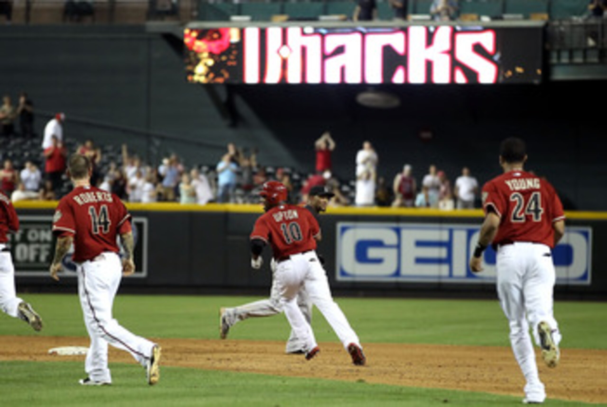 PHOENIX, AZ - JUNE 01:  Justin Upton #10 of the Arizona Diamondbacks celebrates with teammates Ryan Robberts #14 and Chris Young #24 after his game winning RBI single against the Florida Marlins in ninth inning of the Major League Baseball game at Chase F